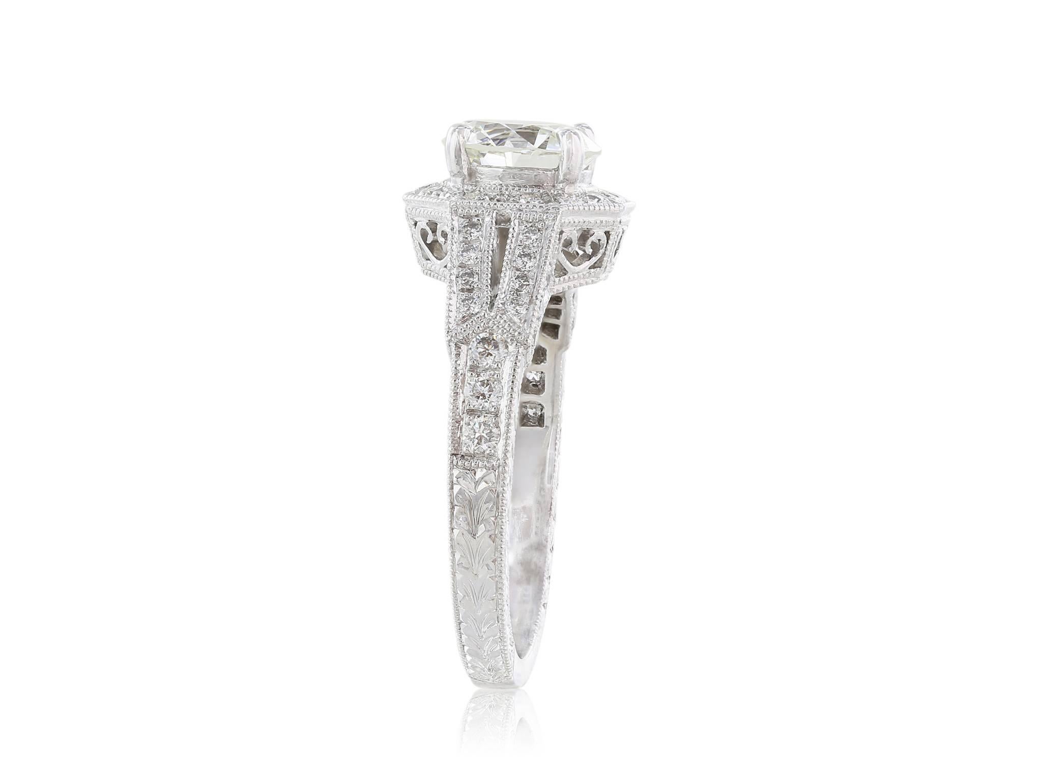 1.31 carat old European cut diamond with a color of I and a clarity of VS1.  The diamond is set in an ornate, hexagon shaped, micro pave diamond mounting with half way diamond shank and millgraine sides. Platinum mounting
