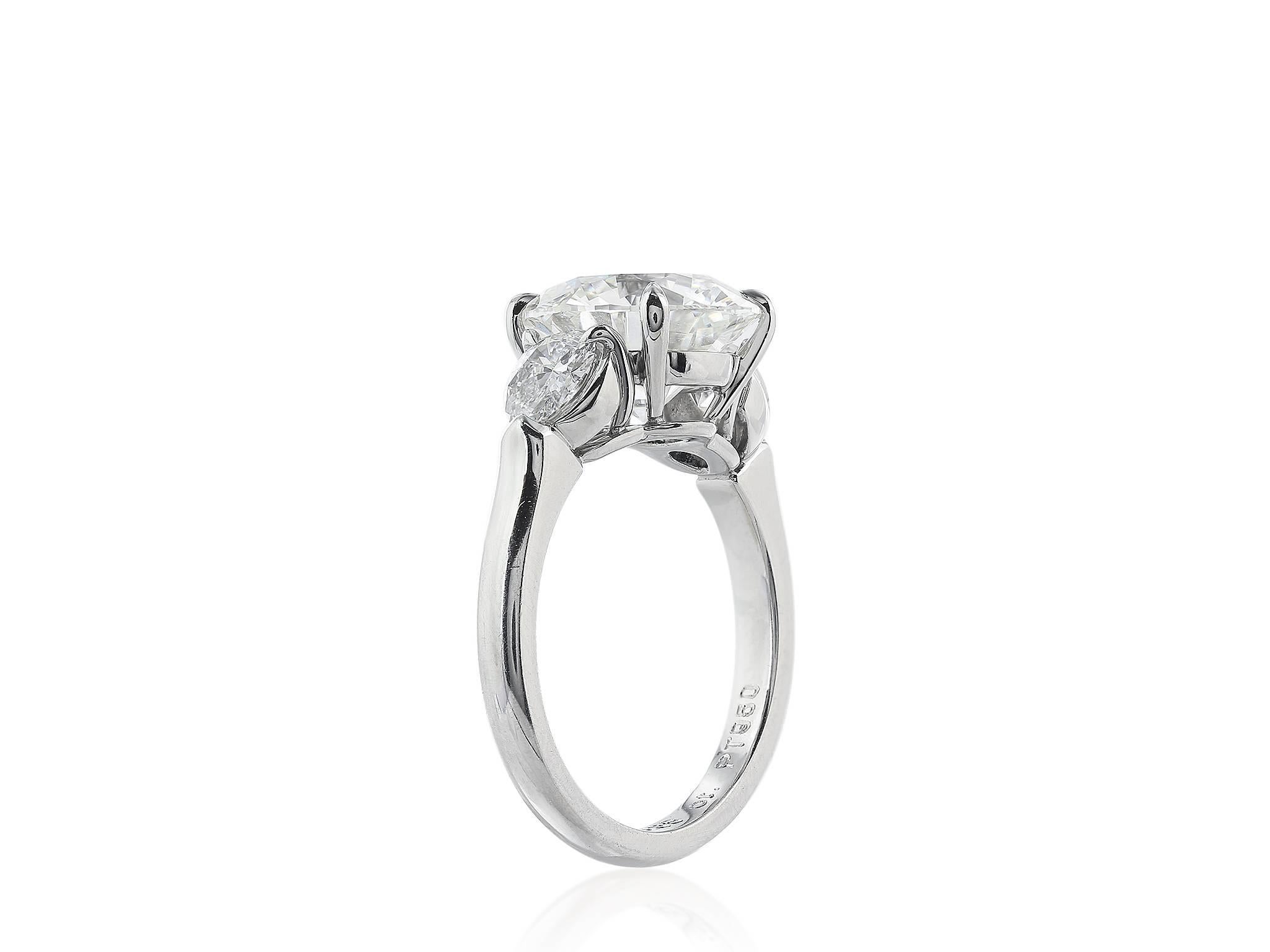 Platinum custom made 3 stone ring consisting of 1 round brilliant cut diamond weighing 3.61 carats, having a color and clarity of J SI1, measuring 9.84X9.86X6.07mm, with GIA certificate #5171354005, the diamond is flanked by 2 round brilliant cut