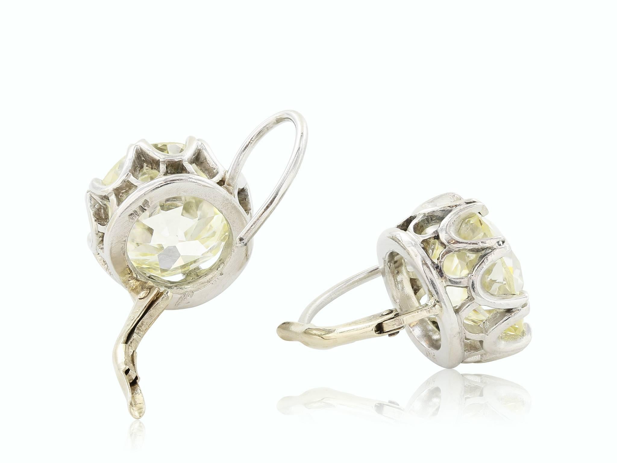 Platinum diamond earrings, featuring two old mine cut diamonds weighing approximately 9.98ctw. having a color and clarity of J/K VS2-SI1 the diamonds are set in a crown basket with lever backs.