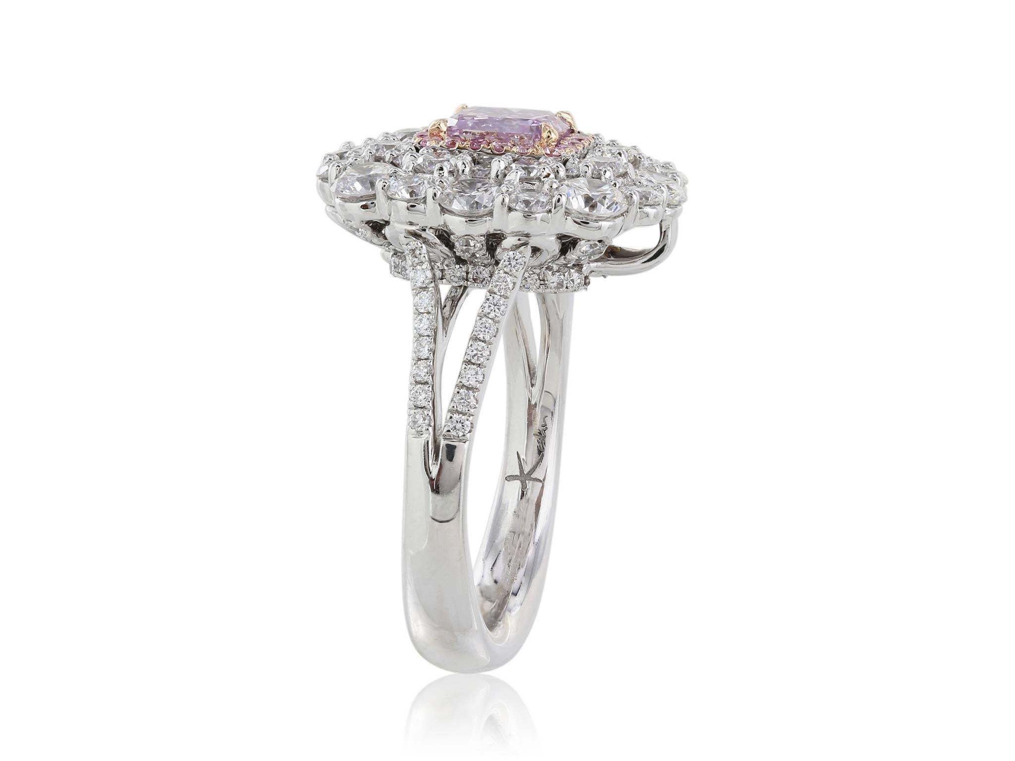 Stunning 18 Karat white gold ring with one radiant cut GIA certified fancy pink-purple center stone with a clarity of I1.  The center stone is surrounded by a halo of round brilliant cut pink diamonds weighing .11 carats and a larger halo of white