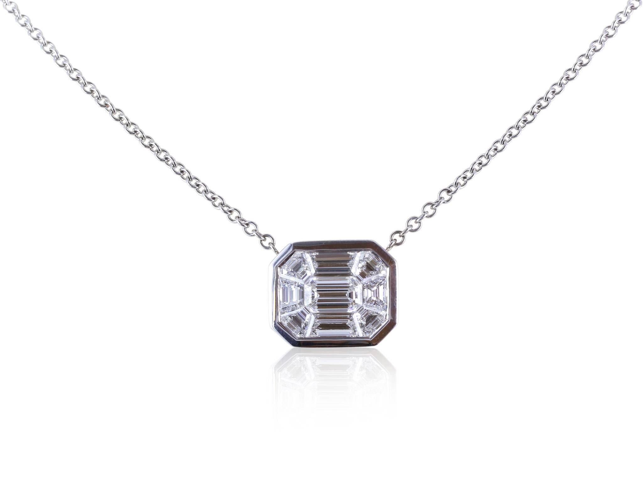 18 Karat white gold diamond pendant containing 9 diamonds of varying shapes combined to make a total weight of . All of the diamonds have a color of G/H and a clarity of VVS.  The pendant is on an 18 inch 18 karat white gold cable chain.