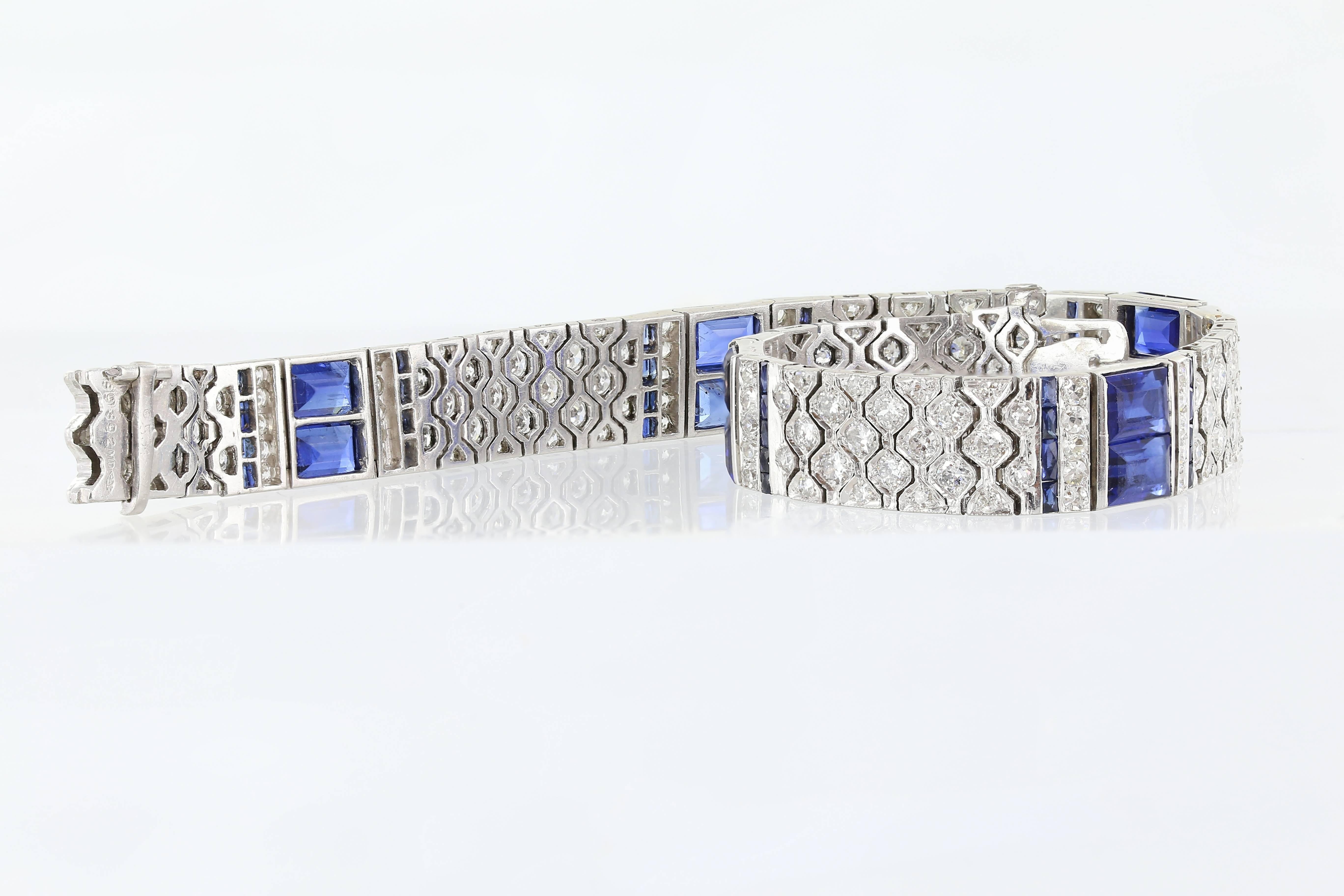 Platinum set signed Charles Hall art deco bracelet featuring approximately 4.5 carats of old mine cut diamonds and approximately 9.5 carats of emerald cut sapphires.  The diamonds have a color of D-E and a clarity of VS1. Charles Hall worked for