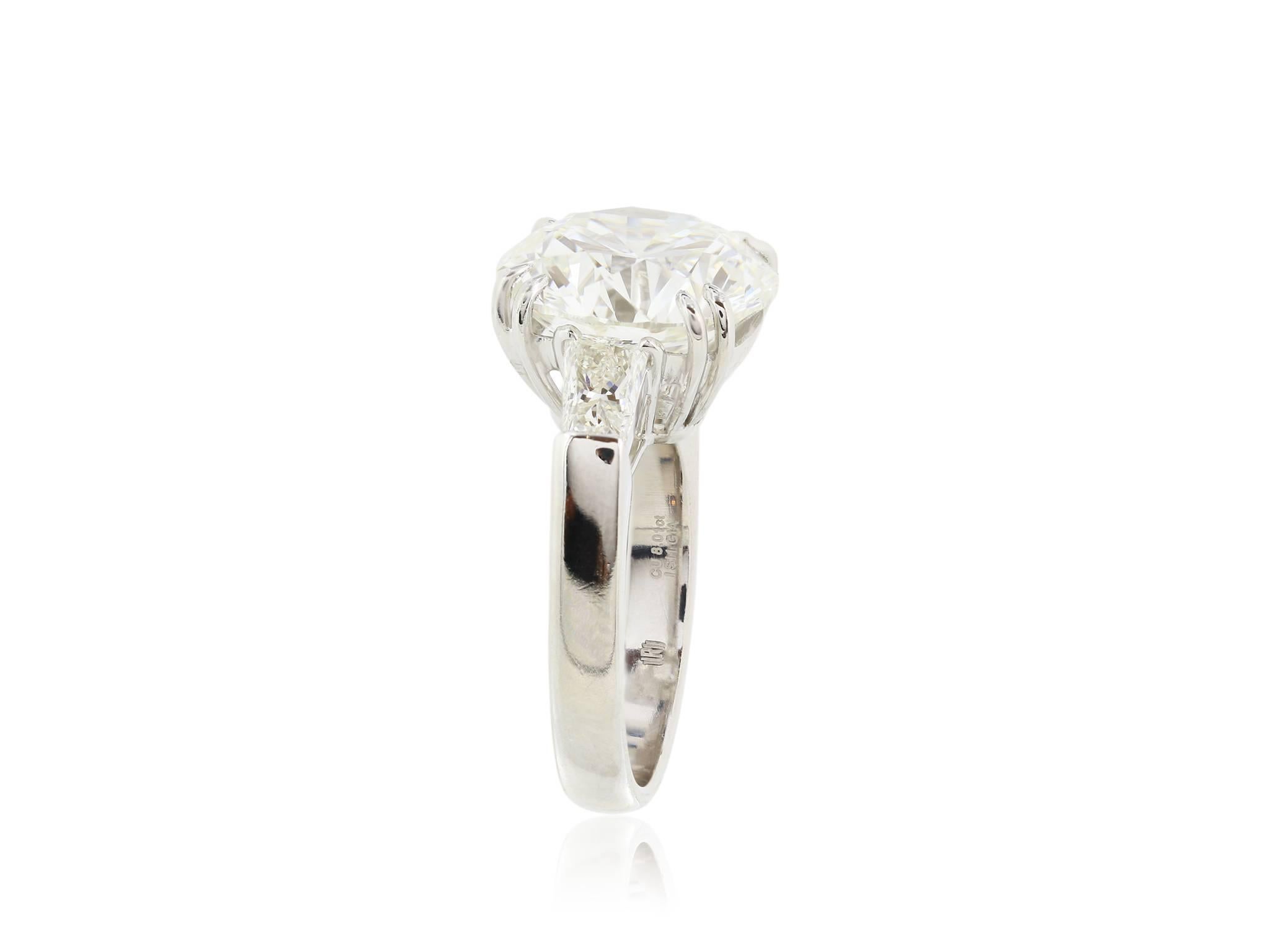 Platinum Diamond ring, featuring one round brilliant cut diamond, weighing 7.54 carats  having a color and clarity of G SI1 the diamond is flanked by two trapizoids.