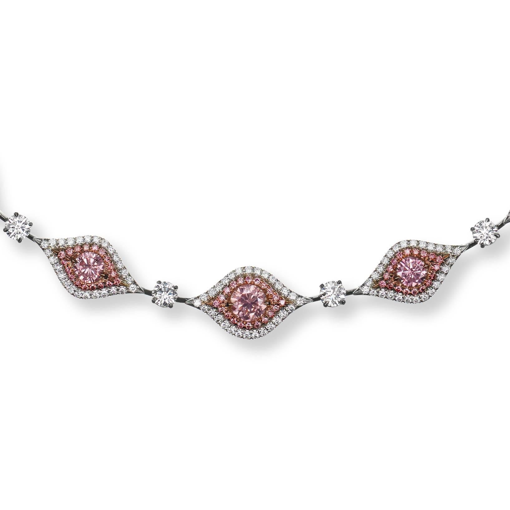 This on of a kind Platinum custom Fancy Intense Pink Diamond necklace features 16 graduated round Argyle Fancy Intense Pink Diamonds ranging in color from Fancy to Fancy Intense Pink and Intense purplish pink with a total weight of 5.80 carats