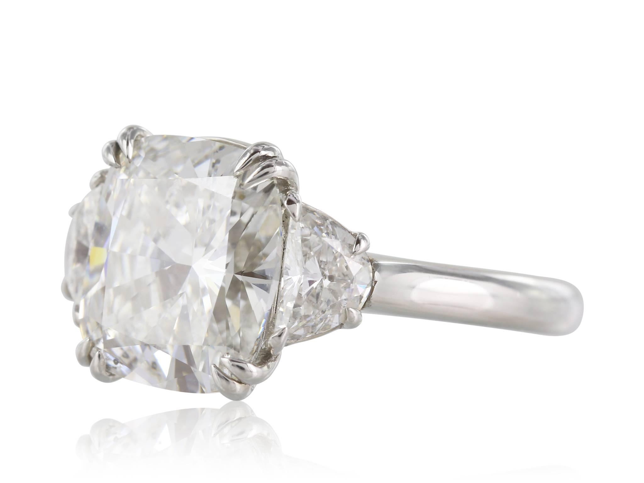 Platinum custom made Cushion cut Diamond weighing 4.01 carats with a GIA #1172206894 G SI2 flanked by a pair of half moon cut diamonds having a total weight of 0.80 carats set in a three stone engagment Ring
