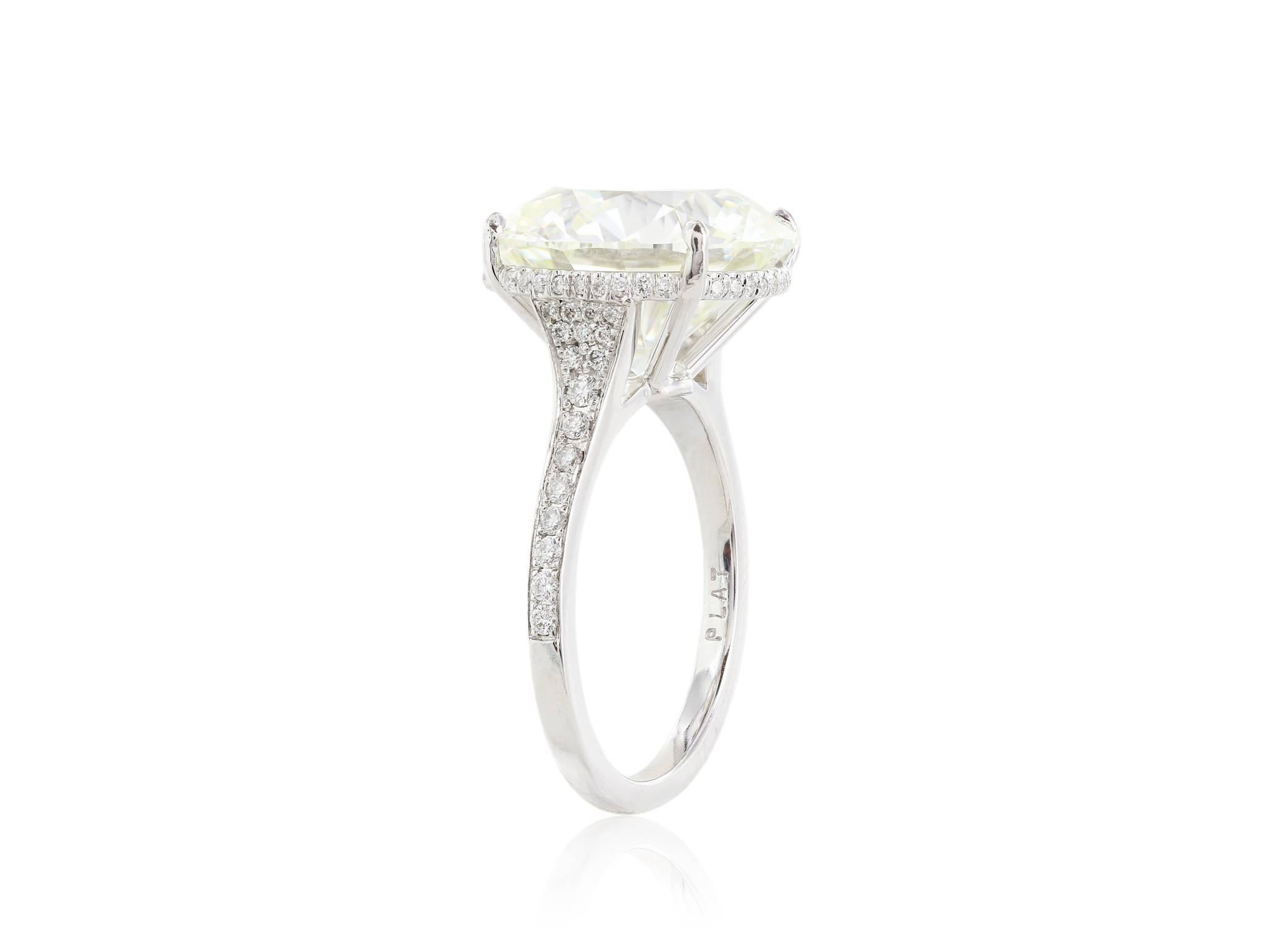 Platinum Diamond ring, featuring one 10.06cts. round brilliant cut diamond having a color and clarity of K/SI1 3X GIA cert# 2165357790 The diamond is set in a diamond mounting with an under gallery halo and diamonds on the band having a total weight