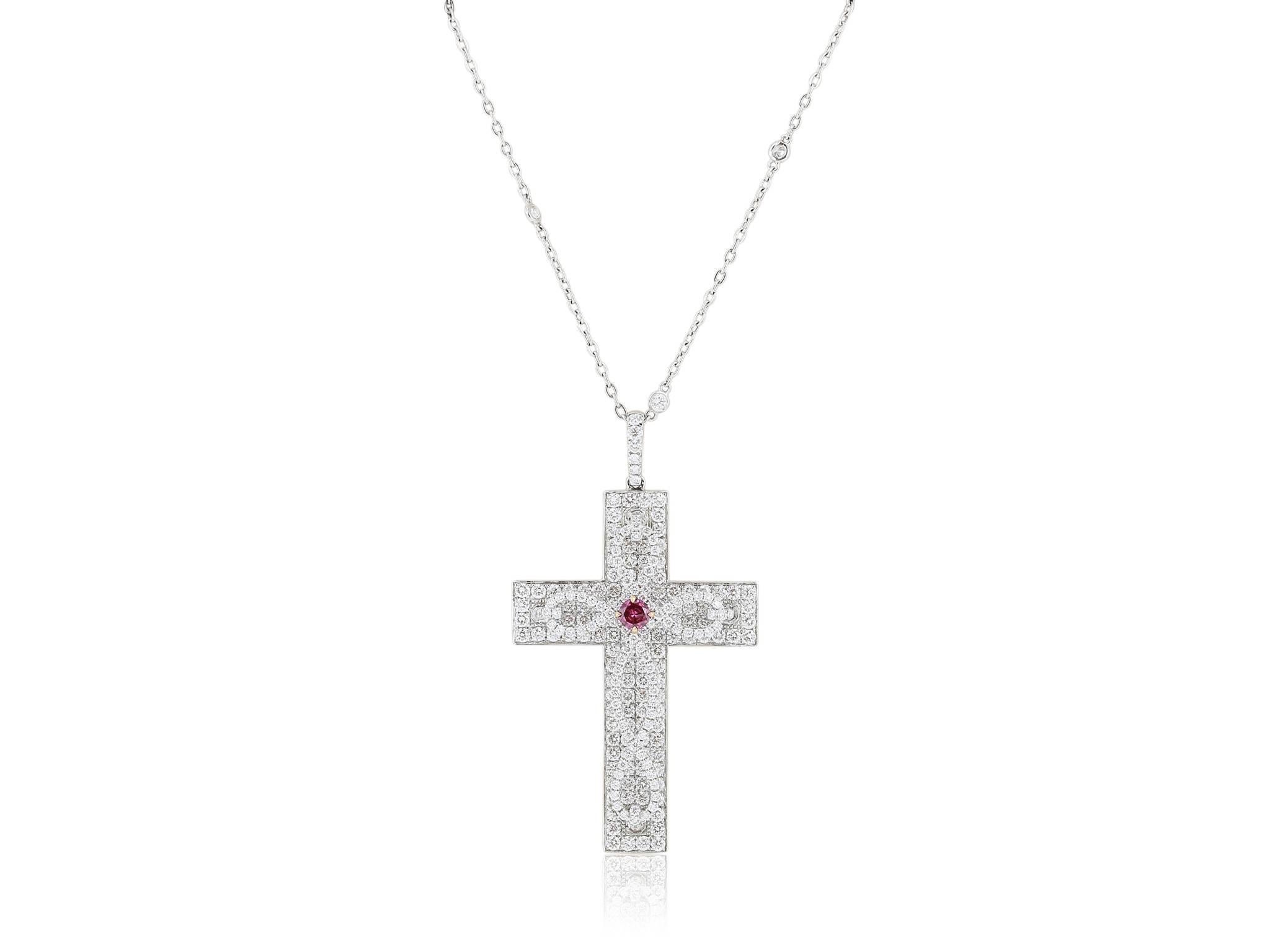 18 karat white gold diamond cross pendant consisting of pave set round diamonds having a total weight of 3.77 carats with  a round Argyle Vivid Pink Diamond in the center having a total weight of .19 carats on a 16 inch 18 karat white gold open link