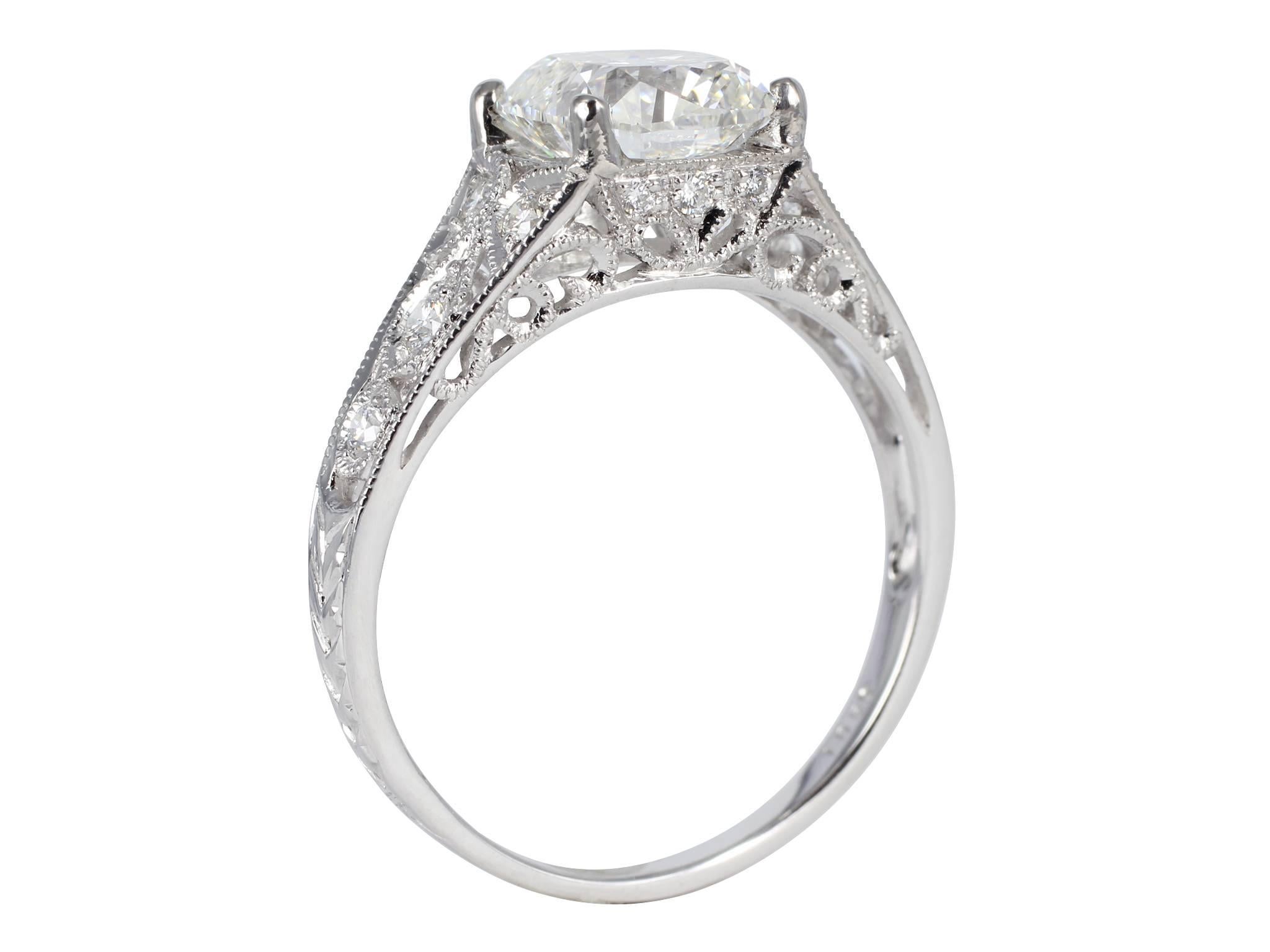 Platinum openwork filigree  consisting of 1 cushion cut diamond, weighing 1.75 carats, measuring 7.19 x 6.77 x 4.75 mm, color and clarity of H/VS2 with GIA Report 2151102505 and accented with full cut round diamonds having a total weight of .19