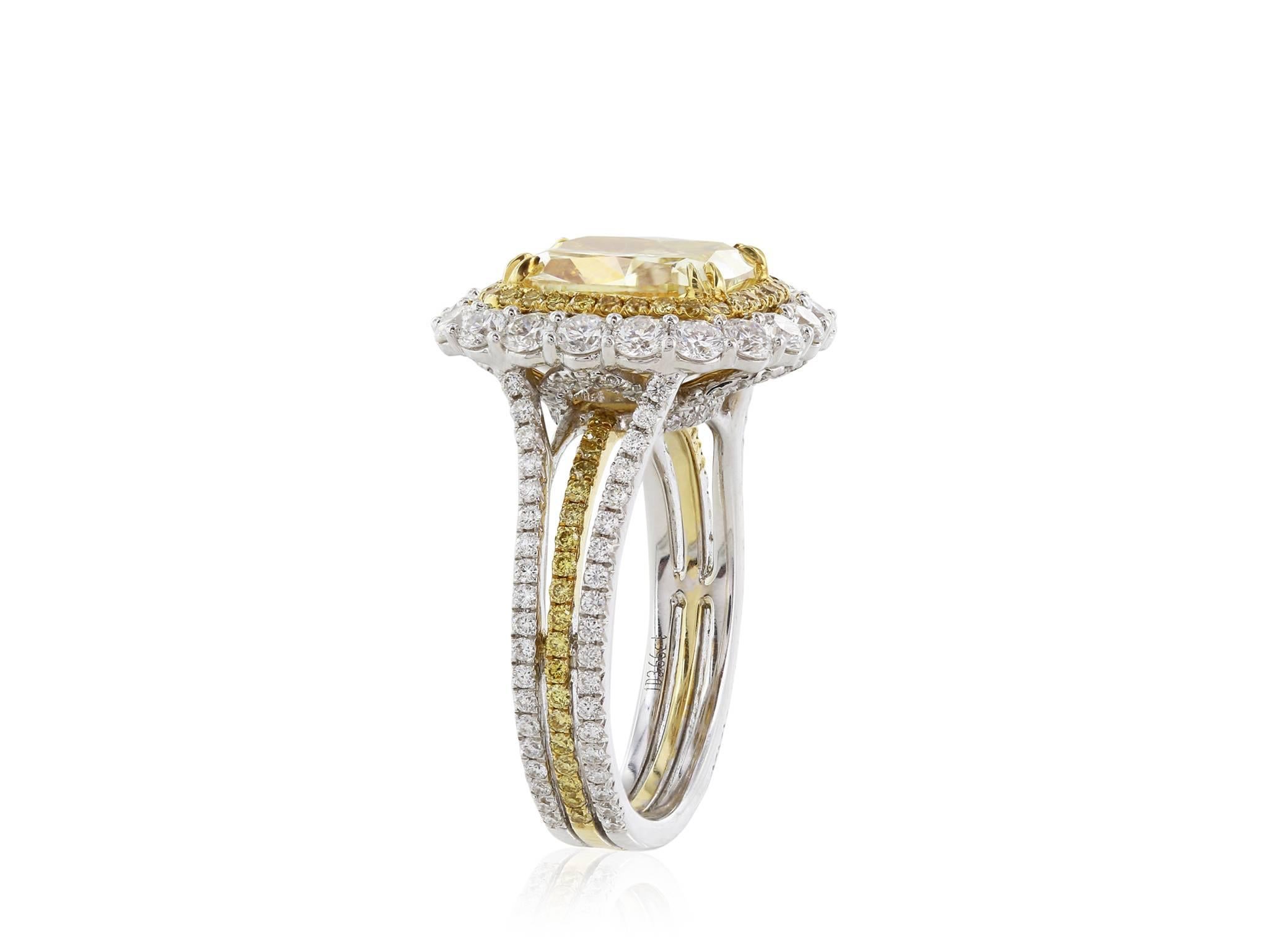 18 Karat white gold diamond halo ring featuring a 3.66 carat radiant cut GIA certified Fancy Yellow diamond with a clarity of SI1.  The diamond is surrounded by two halos of round brilliant cut diamonds.  One has diamonds with a color of fancy