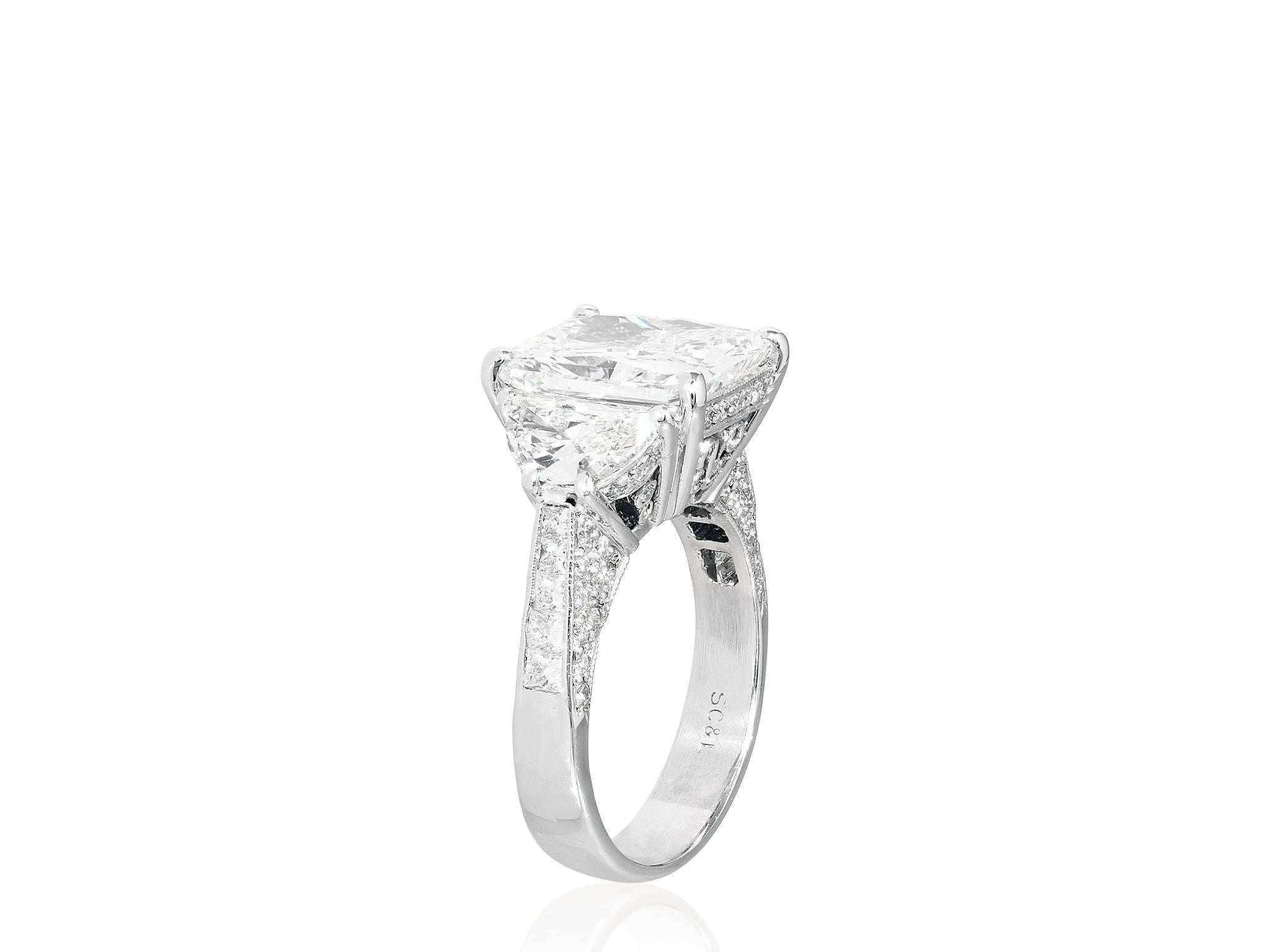 Platinum ring consisting of radiant cut diamond weighing 5.07 carats, having a color and clarity of I/VS2 with GIA certificate, the center stone is flanked by 2 brilliant cut half moon diamonds having a total weight of approximately
