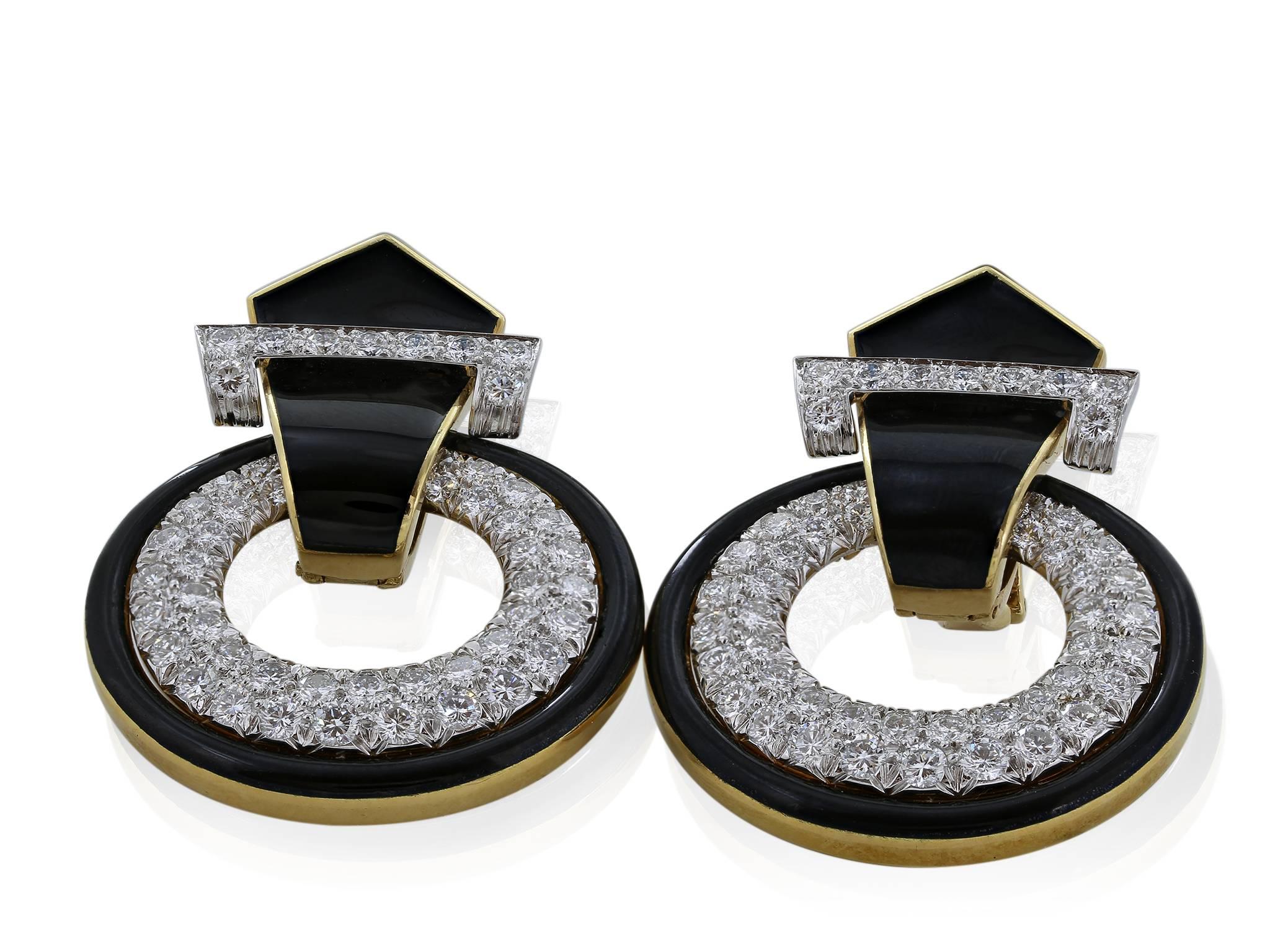 An iconic pair of black enamel coated 18 karat yellow gold and platinum drop hoop earrings with diamond encrusted hoops. by David Webb