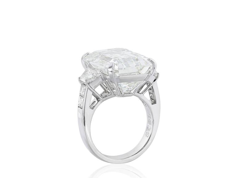 Platinum, Custom made, 3 stone ring consisting of one emerald cut diamond weighing 22.02 carats, measuring 19.10 x 13.44 x 9.34 mm, having a color and clarity of J/VS2 respectively, with GIA certificate 2155417953. The center stone is flanked by 2