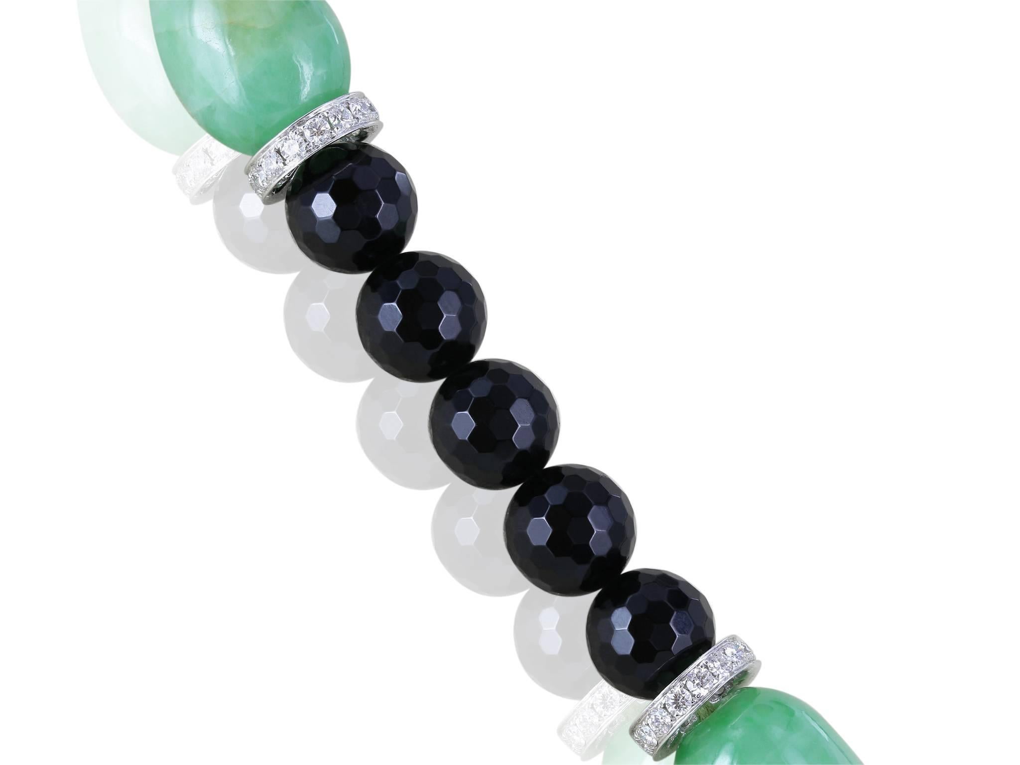 917.09 Carat certified type A Jade necklace interspersed with onyx beads and 18 karat white gold and diamond spacers totaling 2.79 carats.  The necklace also features an 18 karat white gold screw ball clasp with 2.60 carats of diamonds.  44 Inches
