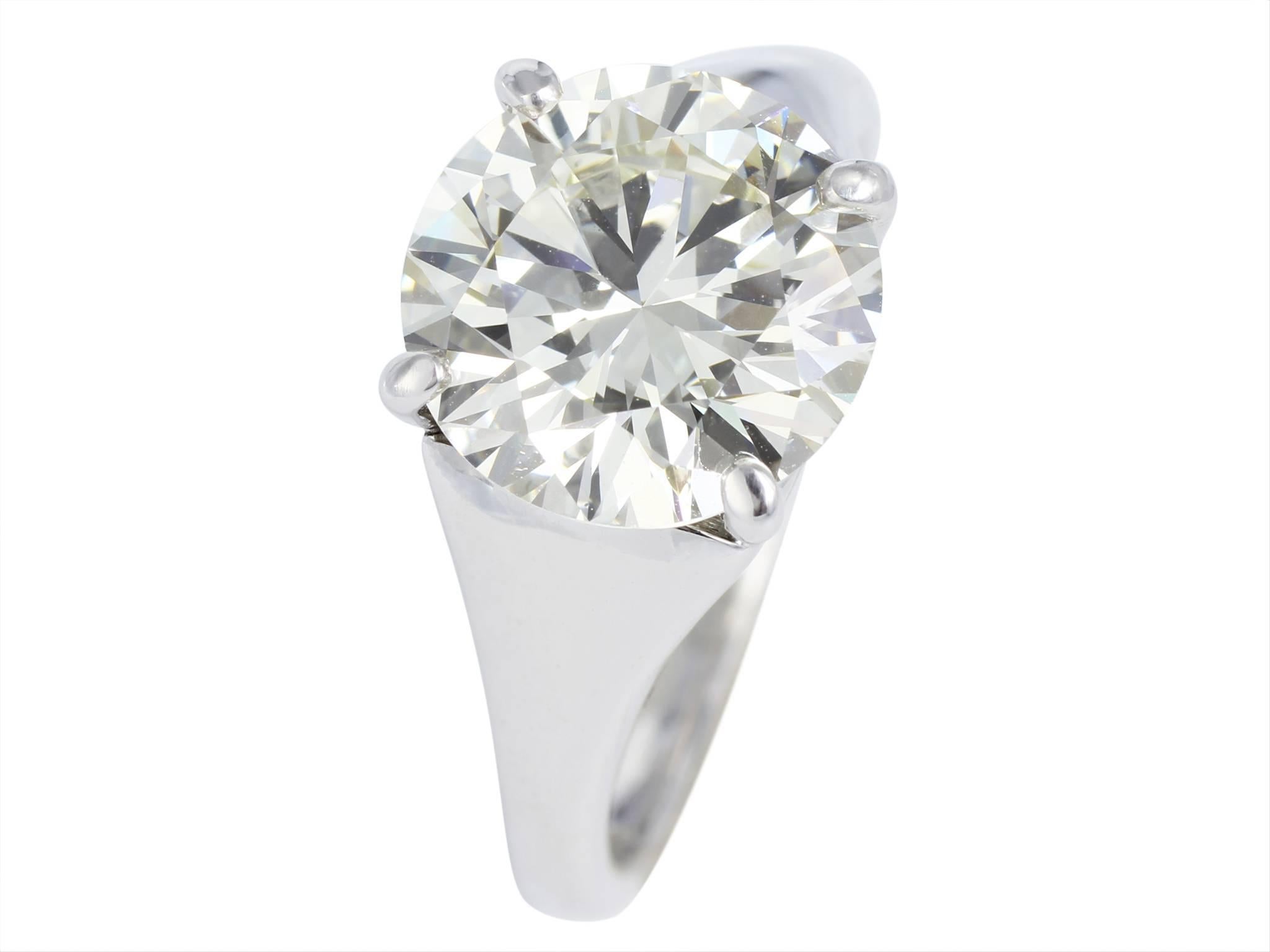 Platinum set 3.77 carat solitaire ring featuring one GIA certified round brilliant cut diamond with a triple excellence rating for excellent polish, excellent symmetry and excellent cut.  The diamond is H color and SI1 clarity, GIA  certificate #