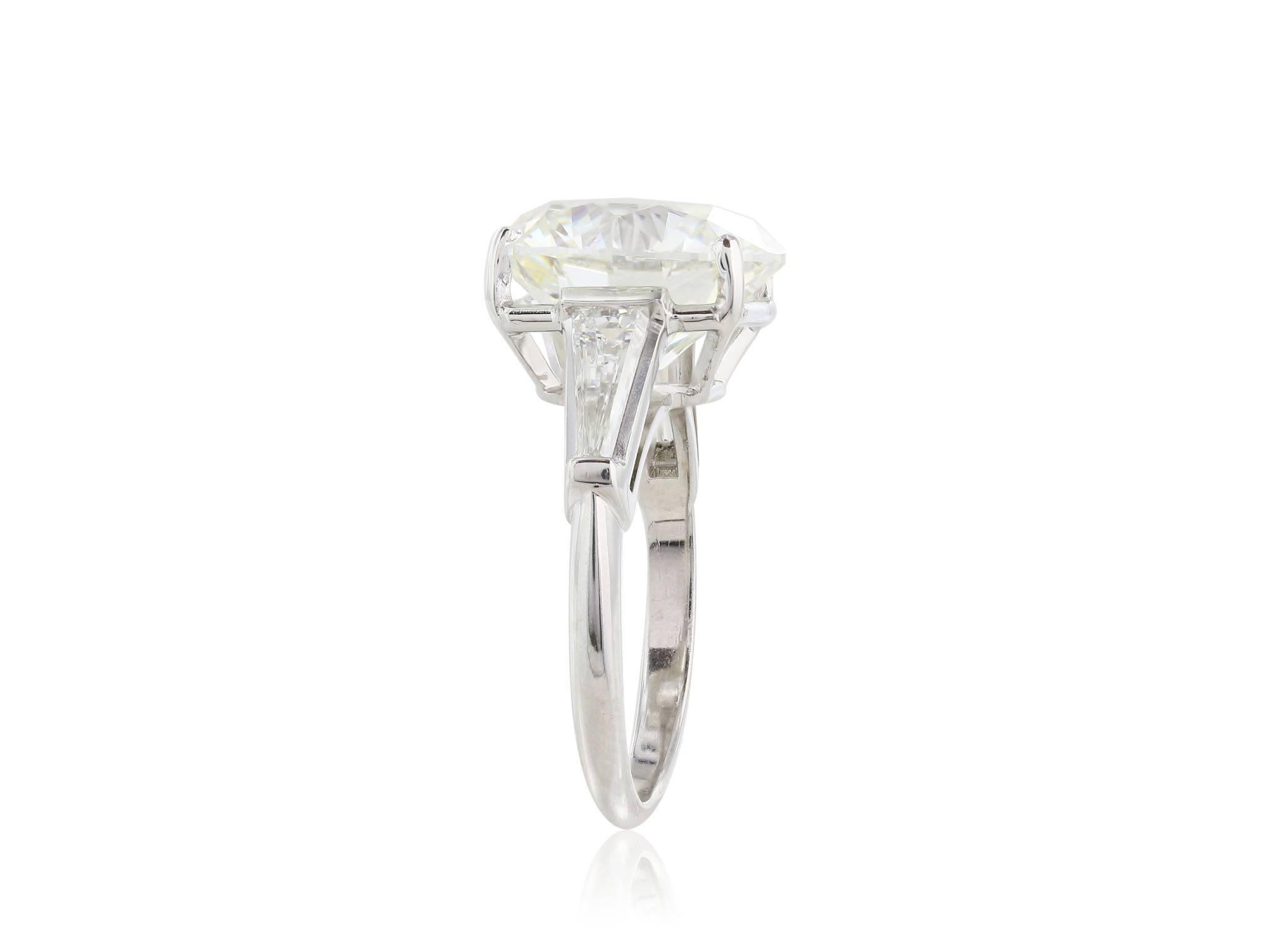 18 Karat white gold  three stone diamond ring featuring one GIA certified (cert # 2173928885) 8.04 carat round brilliant cut diamond with a color of J, and a clarity of VS2 and a triple excellence rating for excellent polish, excellent symmetry and