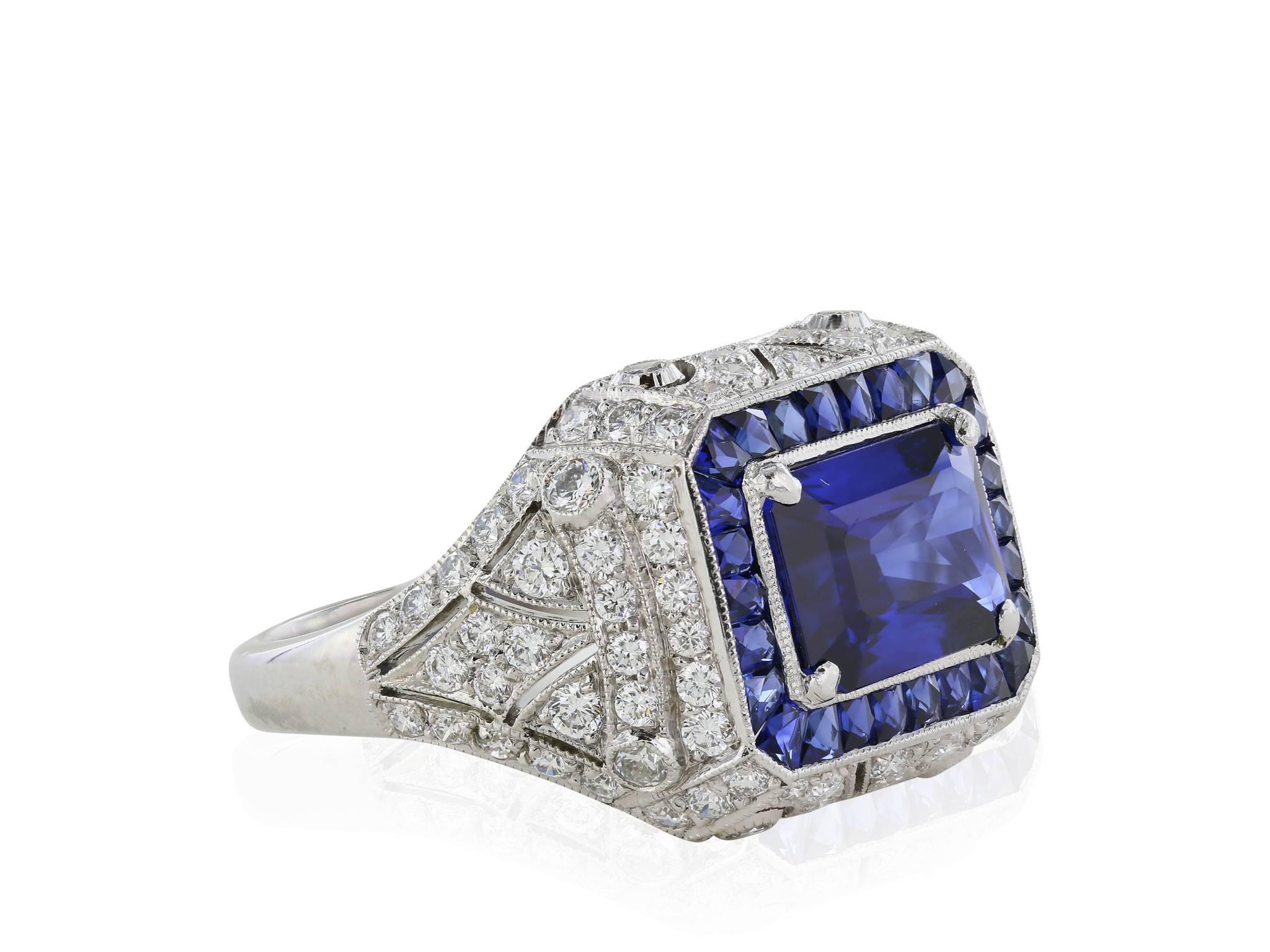 Sapphire and Diamond ring featuring one 2.64 emerald cut sapphire with a GRS report. The sapphire is set in an art deco style platinum sapphire and diamond mounting. There are 26 custom cut sapphires.