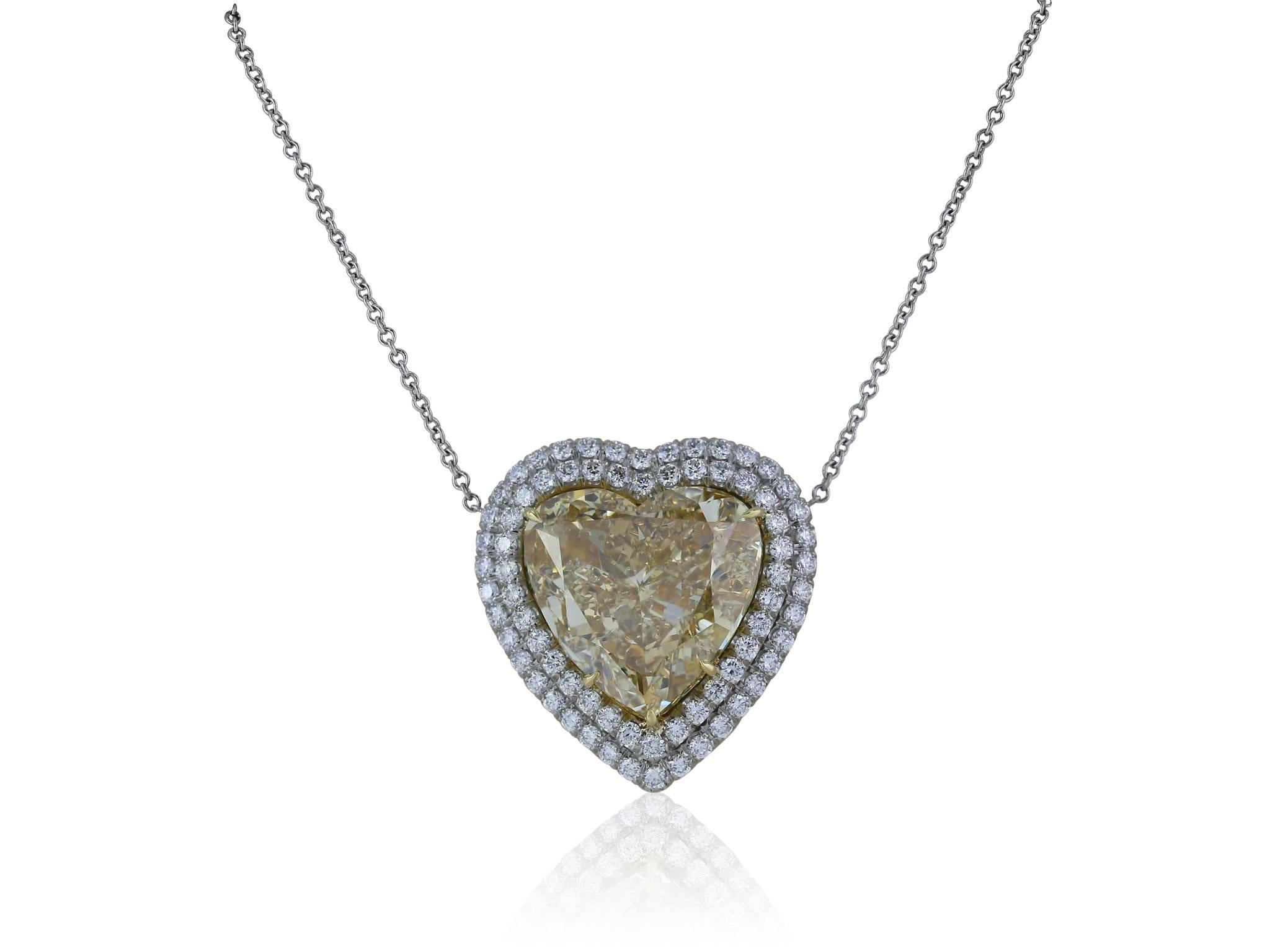 10.02 carat Fancy brownish yellow, Cinnamon heart shaped diamond, surrounded by a double halo of round brilliant diamonds with an approximate weight of 1.20 carats, set in a platinum and 18 karat yellow gold setting with an open work designed back