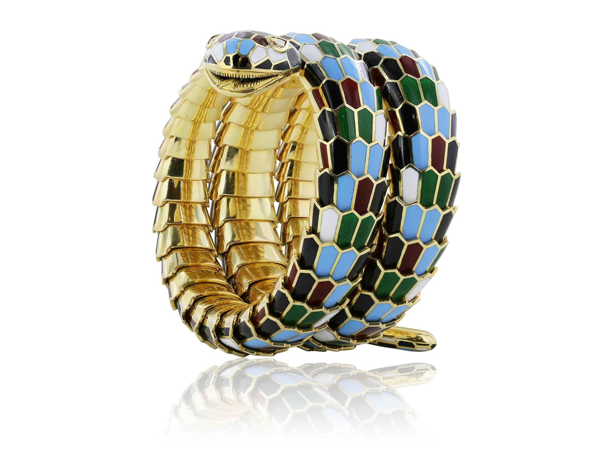 18 karat yellow gold flexible coil , harlequin enamel snake bracelet, featuring green, red, white, black and light blue enamel coiling scales, with 2 bezel set pear shape cognac diamonds for the eyes. 117.95 dwt, 183.44 grams.