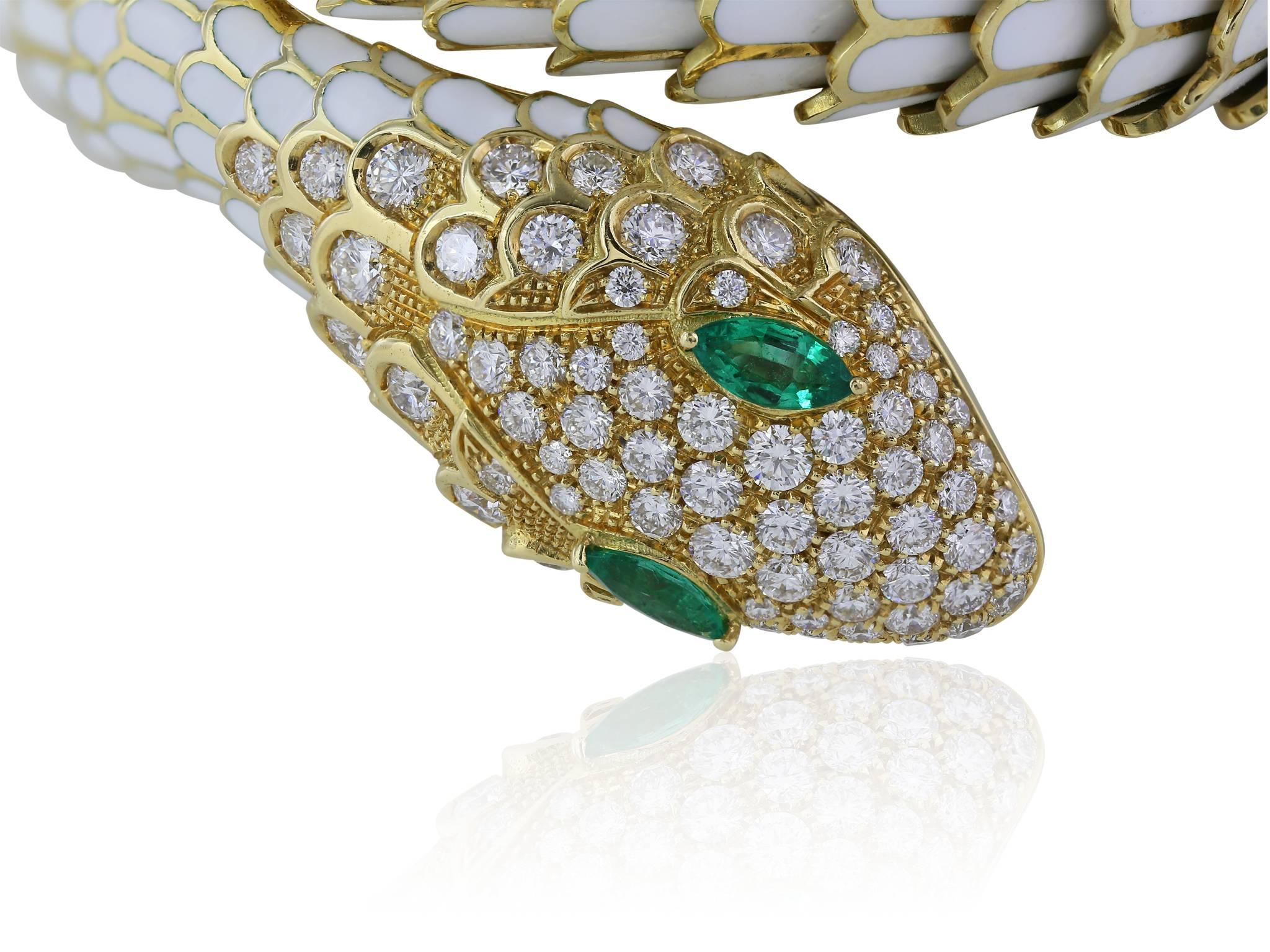 18 karat yellow gold diamond and emerald eye coiling snake bracelet, white enamel on each individual scale, full cut diamonds accenting the face and tip of the tail, with a weight of 2.48 carats with a color and clarity of F VS1-VS2 respectively,