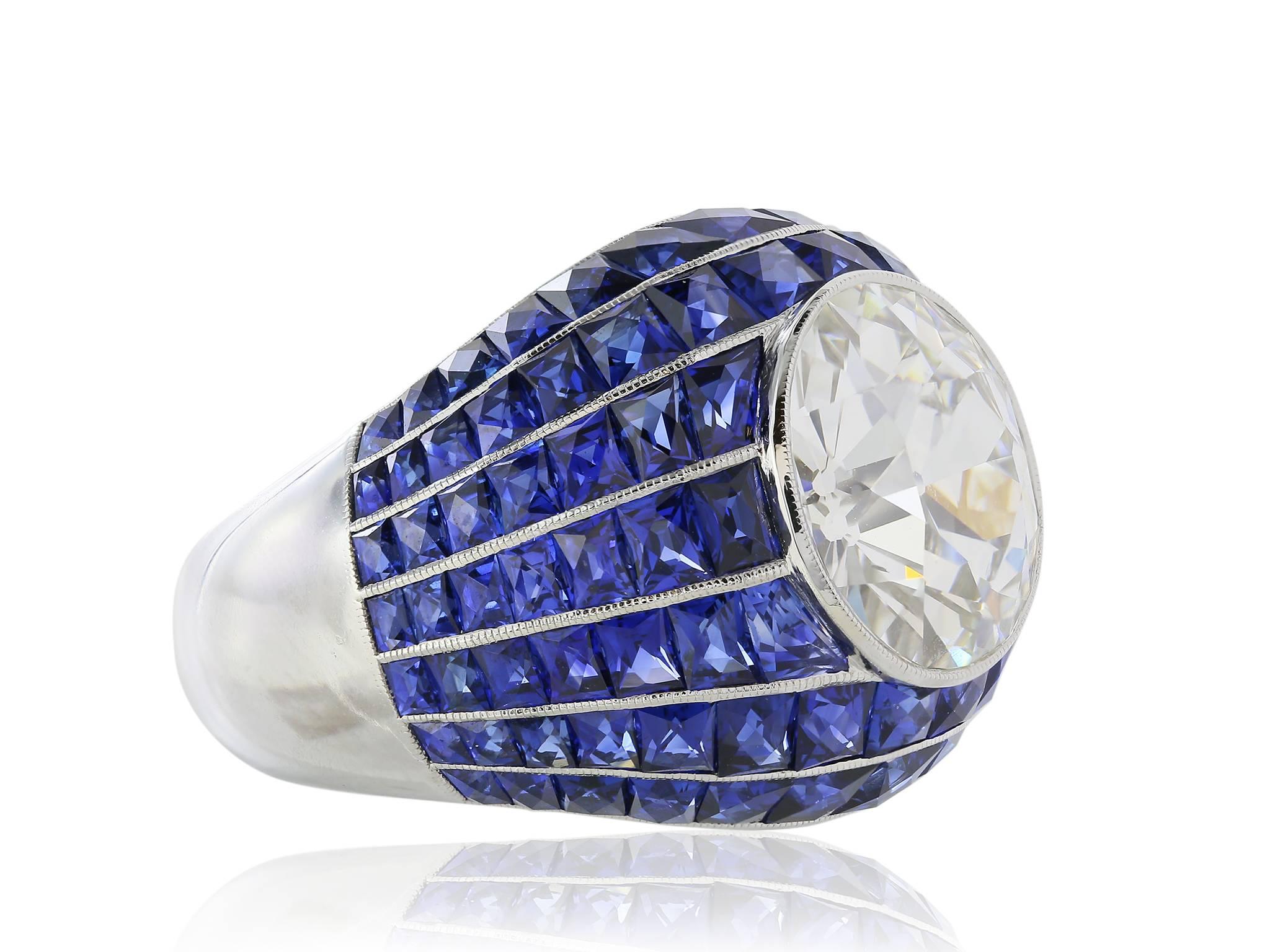 Platinum diamond and sapphire ring, featuring one 5.03ct. Old European Cut diamond GIA certified J/VS2 set with 7.35cts of square cut sapphires.
