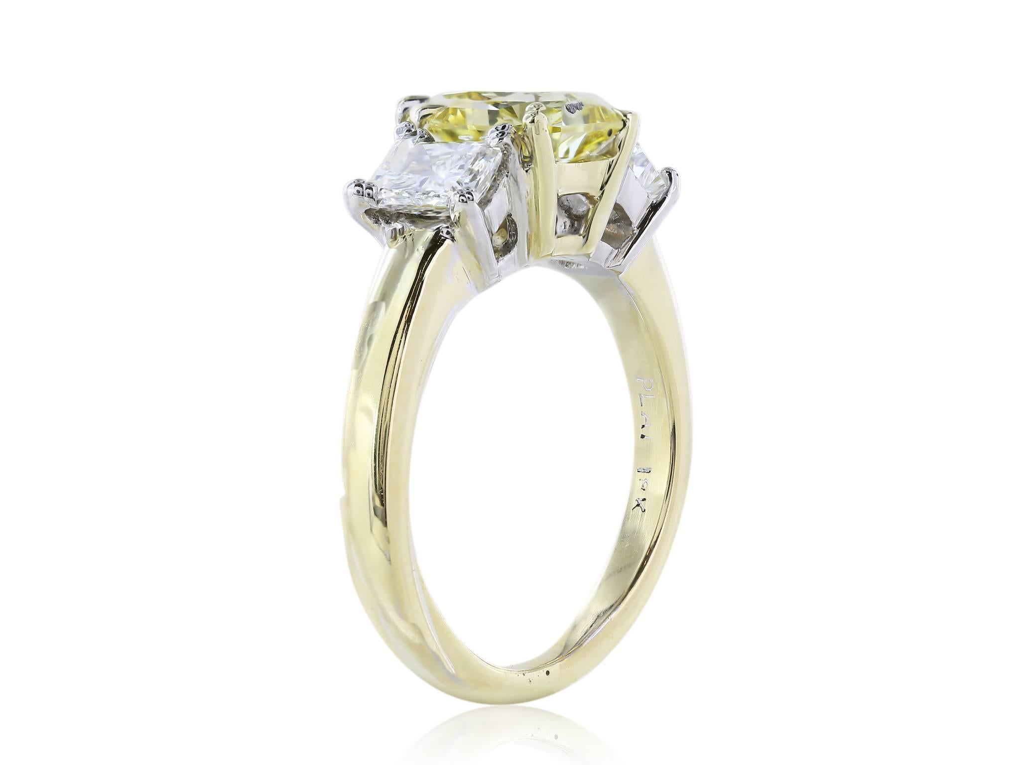 Three stone engagement ring of 1 Fancy Yellow radiant cut diamond weighing 1.66 carats, measuring 7.19 x 7.11 x 3.95 millimeters, with a clarity of VS1, flanked by two radiant cut diamonds weighing .84 carats with a color and clarity of G VS1-VS2