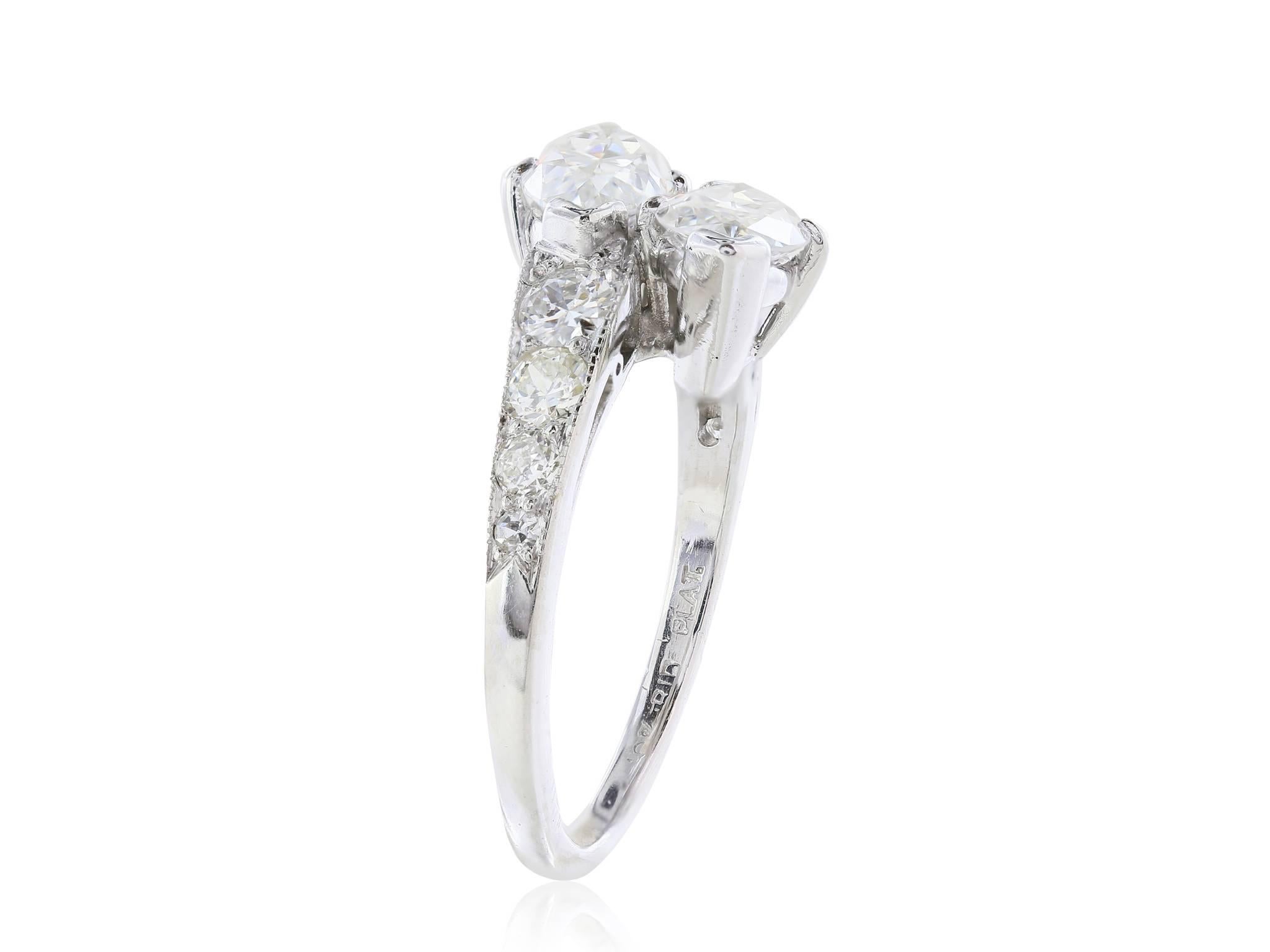 Platinum Marquise Diamond By Pass ring. Consisting of  two Marquise cut Diamonds having a total weight of approximately 2.65 carats flanked by 8 old European cut diamonds