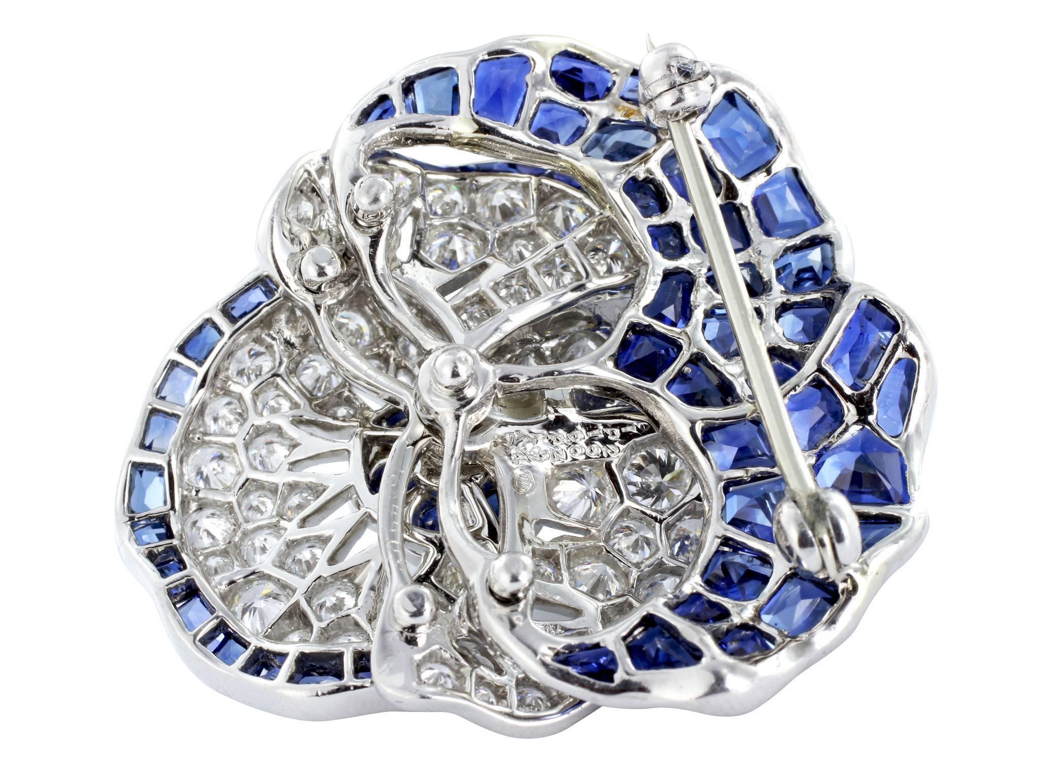 Platinum blue  sapphire and diamond pansy pin consisting of 48 mixed cut blue sapphires, , and 28 round brilliant cut diamonds weighing 2.96. Stamped by Oscar Heyman #200394