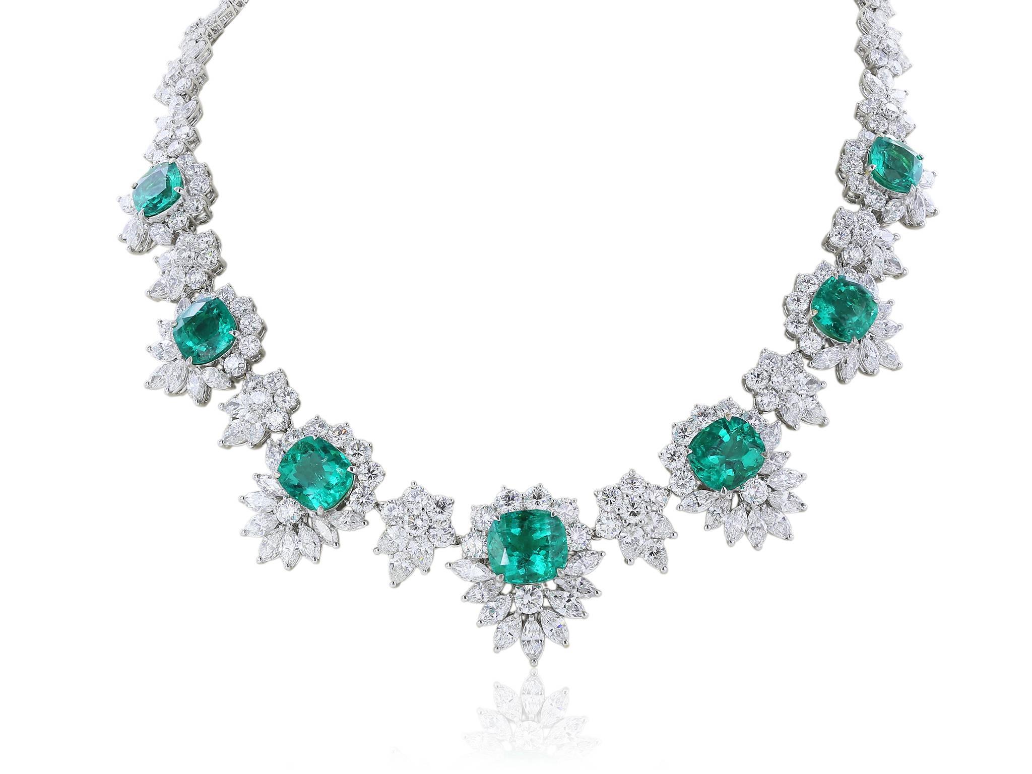 
This custom made Shreve, Crump & Low necklace and earring suite is fit for a Queen  in 18 karat white gold spectacular custom made Colombian Emerald and diamond cluster earring and necklace.  Consisting of 8 cushion cut brilliant Colombian emeralds