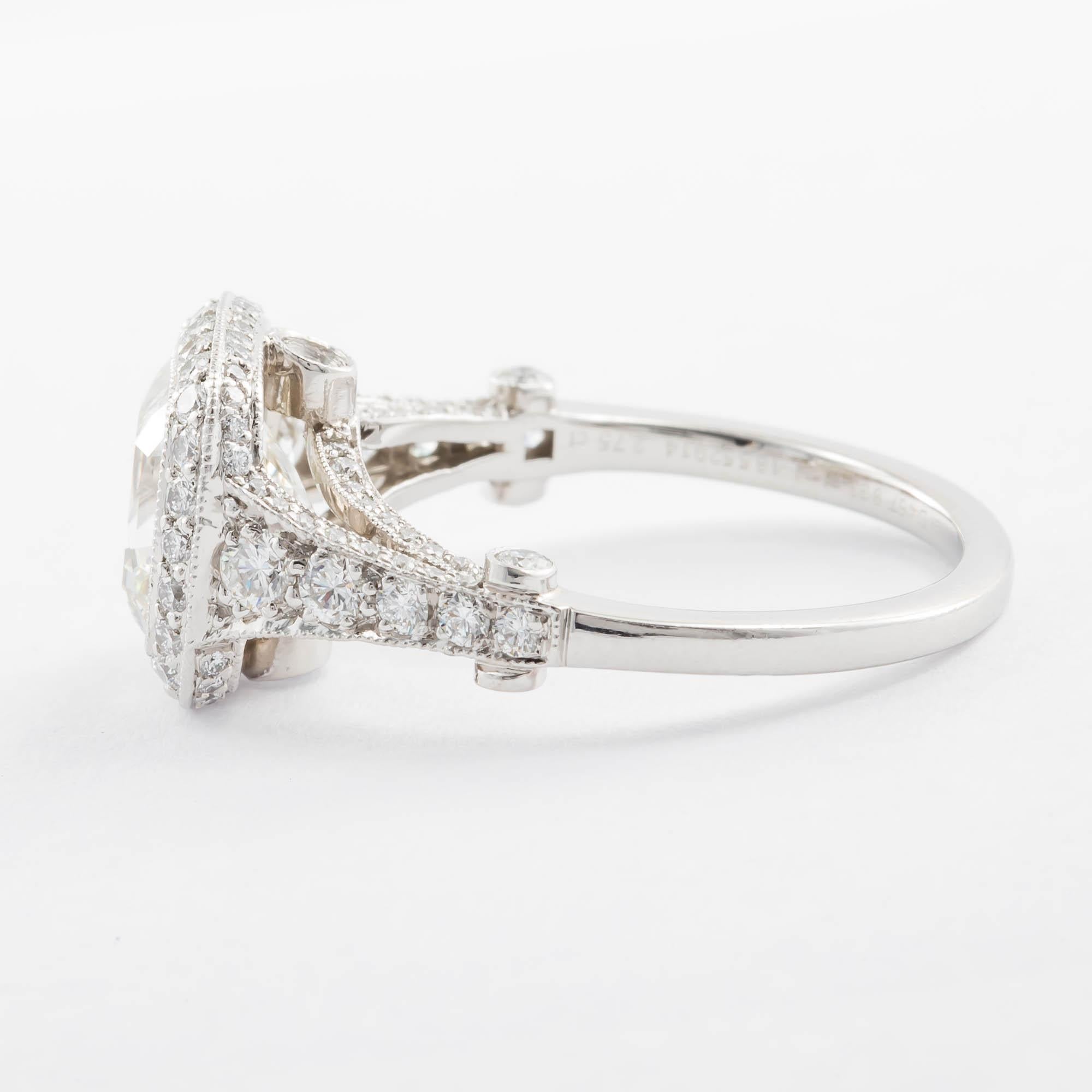 Platinum cushion diamond engagement ring by Tiffany & Company. Consisting of one GIA cushion cut diamond weighing 2.75 carats with color and clarity grade of I VVS1 the diamond is set into a stunning beaded bezel set pave mounting with diamonds set