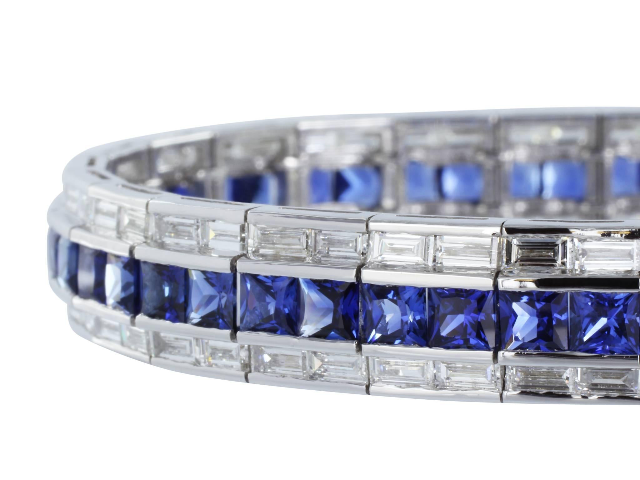 18 karat white gold flexible 3 row bracelet consisting of 1 center row of 52 french cut sapphires having a total weight of 12.69 carats with 2 rows of baguette cut diamond on either side having a total weight of 6.59 carats.