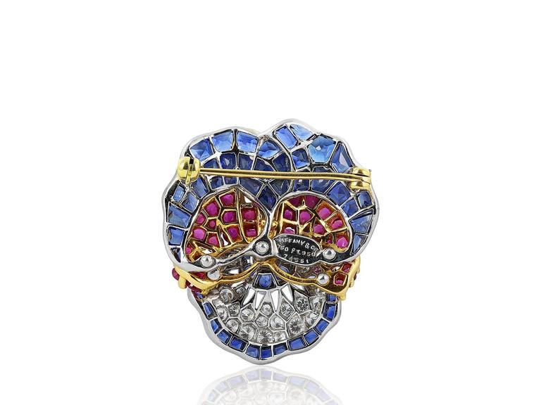 18 karat yellow gold and platinum blue and fancy pink sapphire and diamond pansy pin consisting of 48 mixed cut blue sapphires, 5 round cut blue sapphires, 30 round cut fancy pink sapphires, and 28 round brilliant cut diamonds. Stamped by Oscar