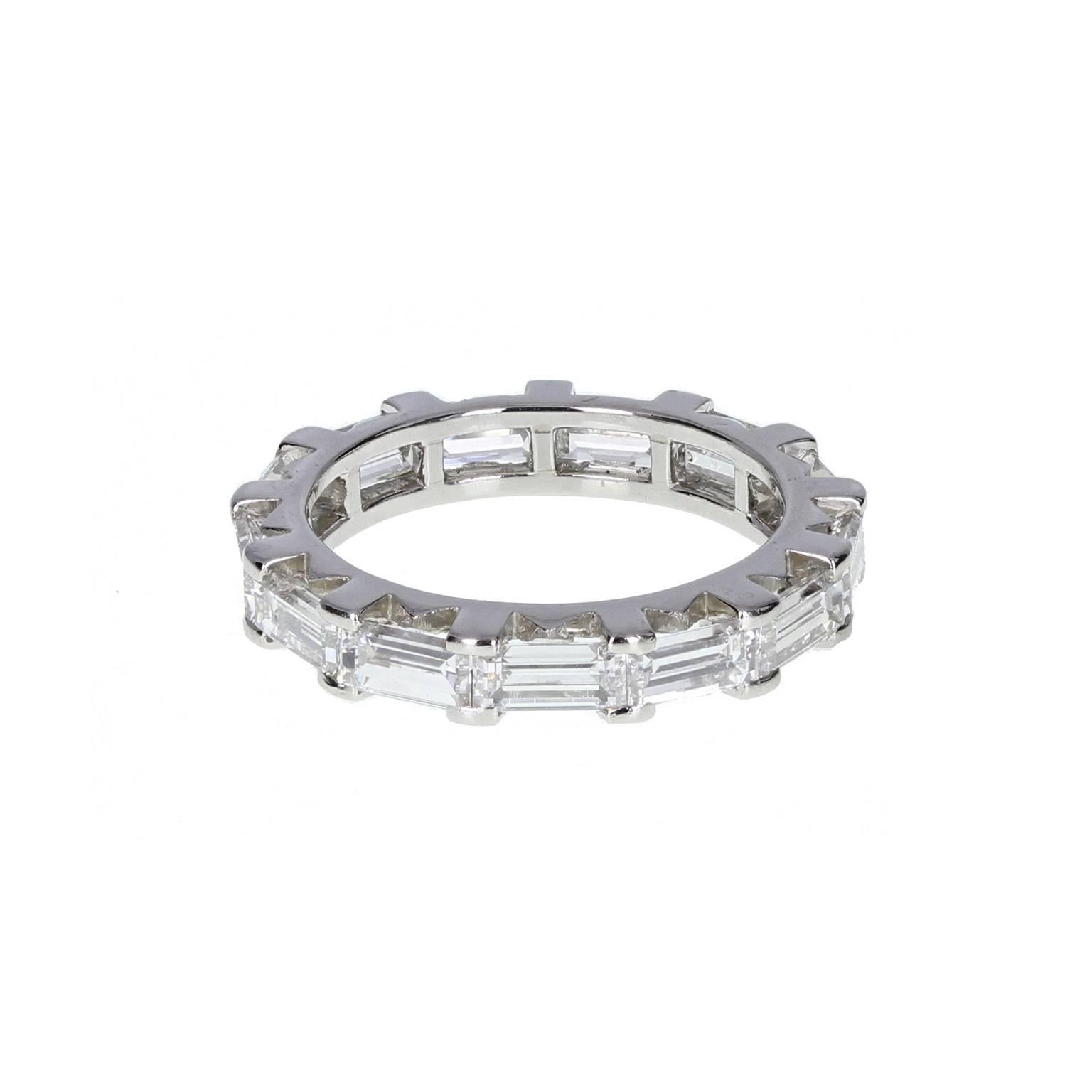  From arguably the finest name in jewellery, this exquisite full-hoop eternity ring is crafted to the highest standard. A full platinum hoop mounted with 13 very well matched baguette-cut diamonds in perfectly spaced claws. Signed 'Cartier Paris'.