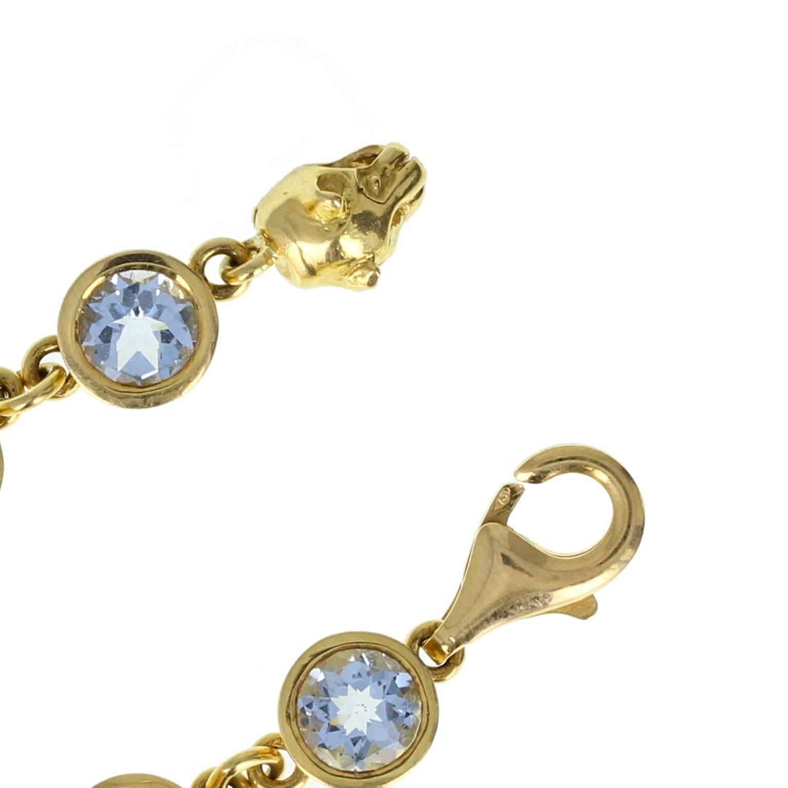 An exquisite quality tennis/line bracelet in 18 carat yellow gold. 14 perfectly matched brilliant-cut aquamarines, each in a bezel setting, linked together with a jump ring to form a uniform line bracelet. Lobster style clasp with a leopards head