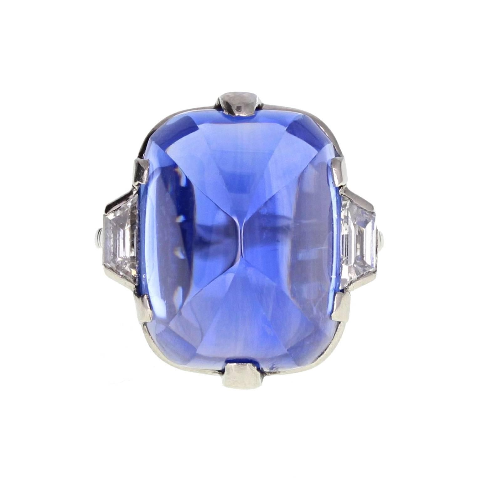 This exquisite Art Deco ring features a stunning 'Sugarloaf' sapphire with unusual and beautiful faceted corners. Accompanied by a certificate stating that the sapphire is a massive 30 carats, is from Ceylon and has not be subjected to any form of