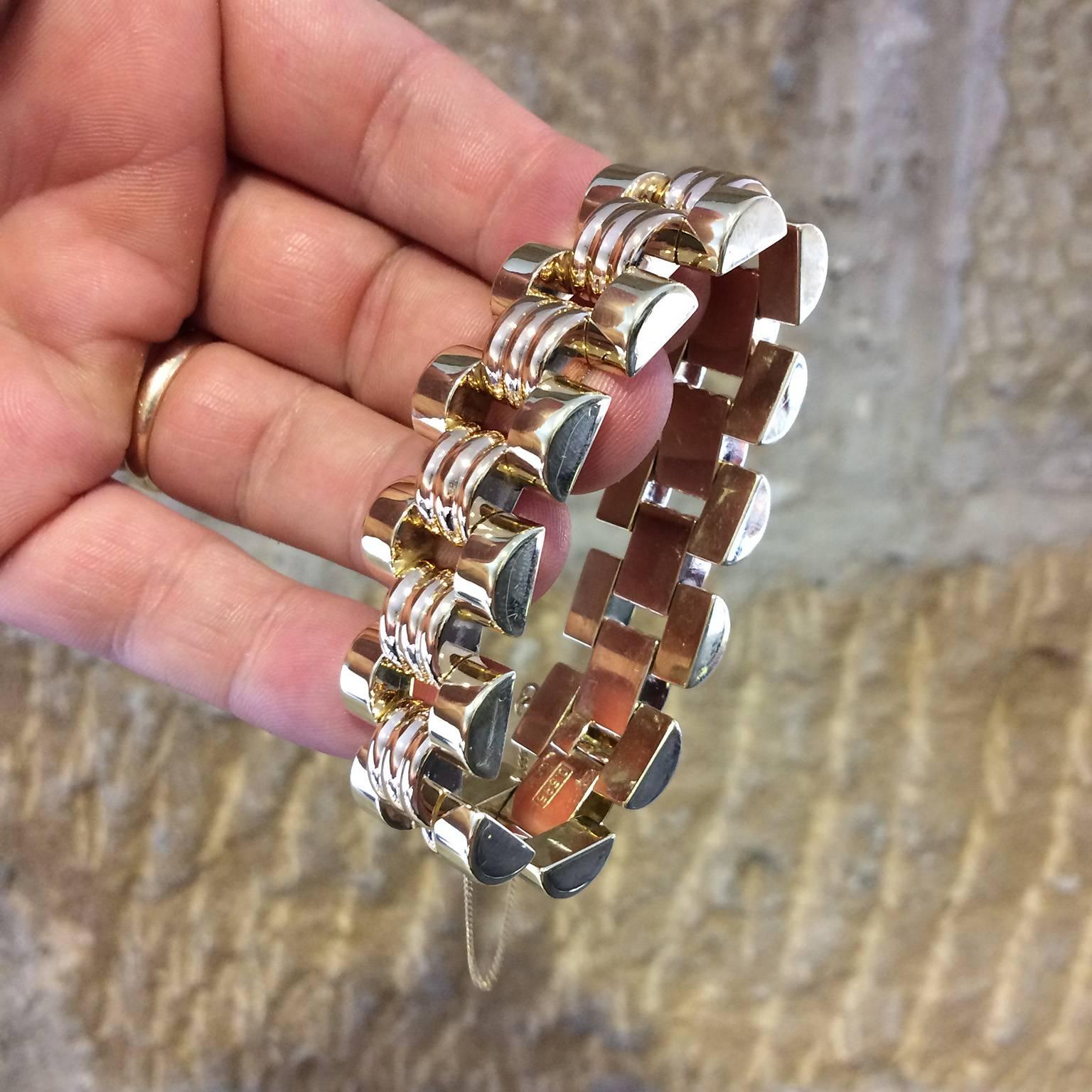 A fine, stylish and impressive vintage gold bracelet. Featuring semi-circular links arranged in a brick pattern. The outer links are high polished yellow, the centre links in rose with three ridges. Two spare links can be refitted to lengthen the