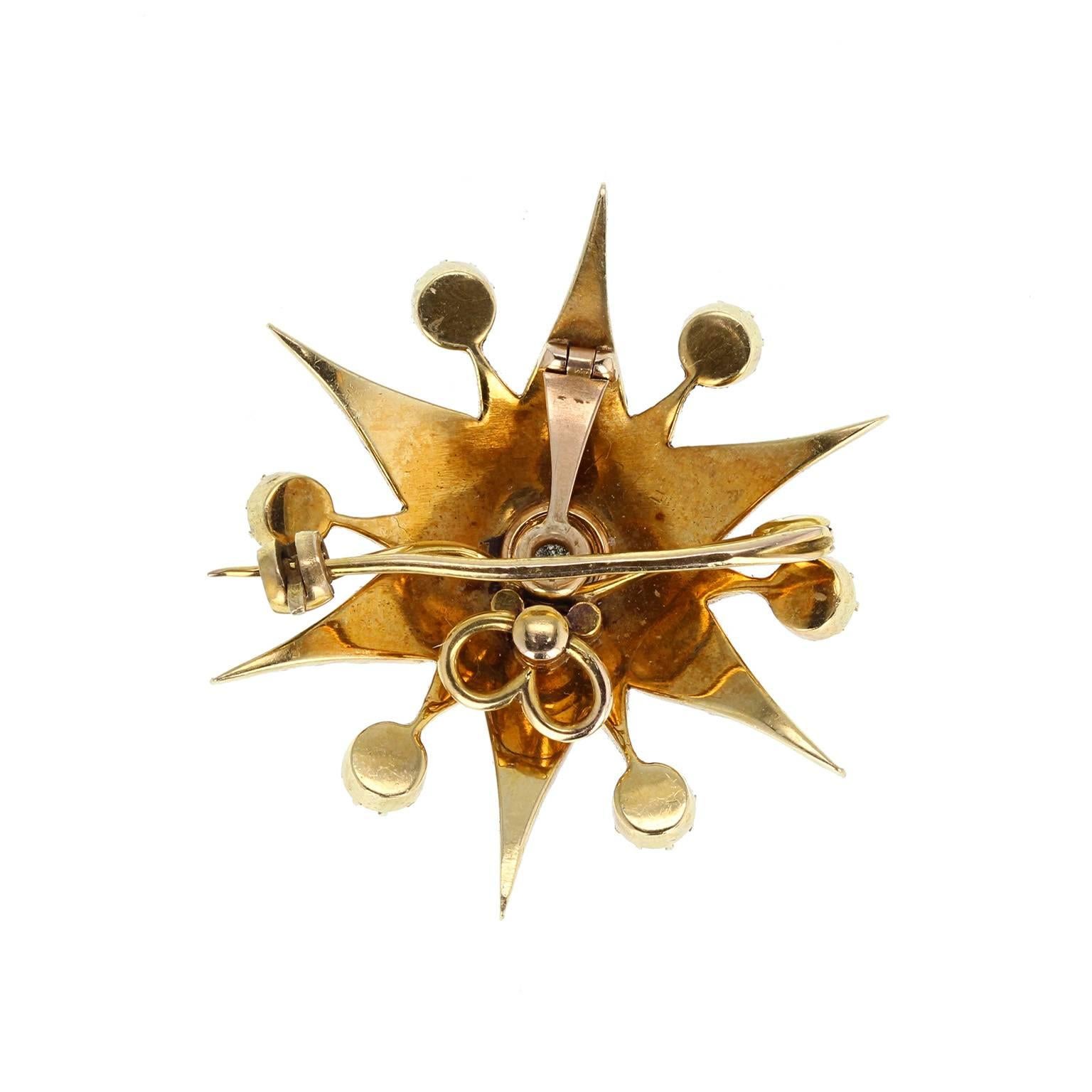 A beautiful antique brooch crafted in 18 carat yellow gold in a starburst style. Pave-set with split pearls, graduating in size, with six 'satellite' pearls radiating between each point. A single old mine-cut diamond sits at the centre. With