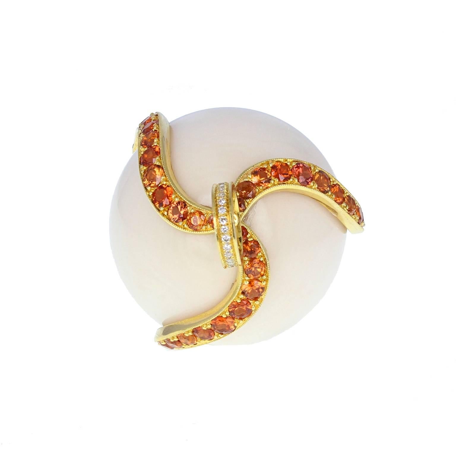 phere of white coral, with some very fine pink veins, held in a three fingered 'claw' of 18 carat gold, pavé set with brilliant-cut fire opals. Large gold bale with, pavé set with diamonds. A particularly striking piece.
Accompanied by a