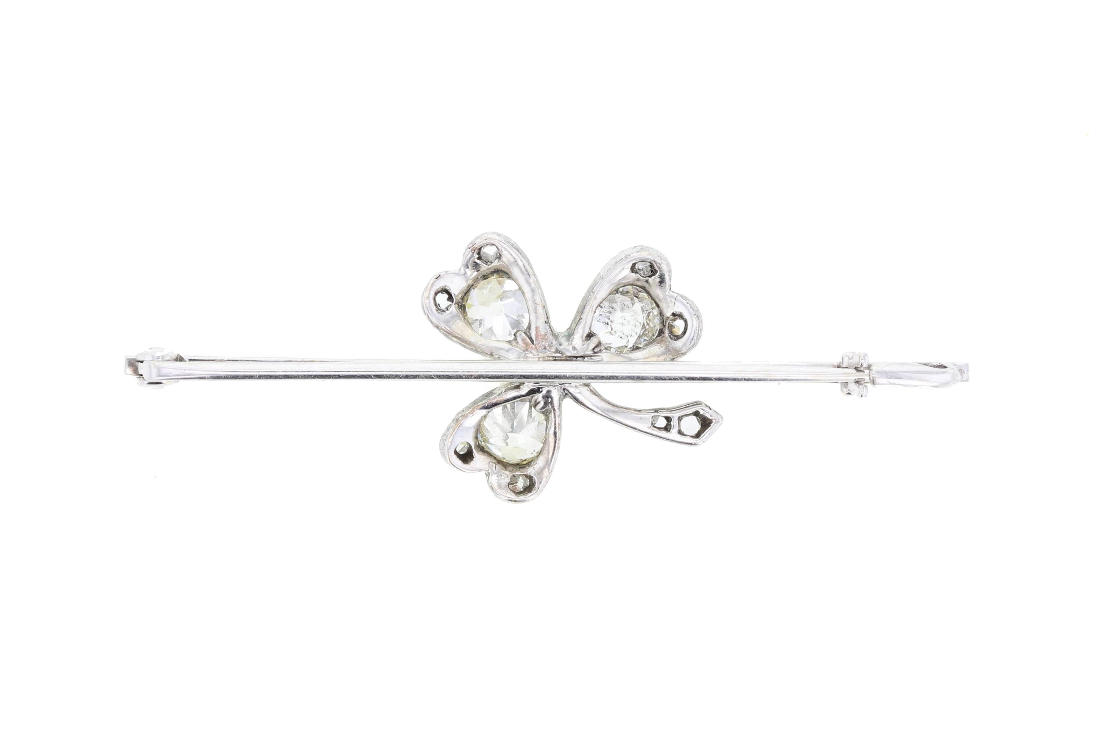 A wonderful antique bar brooch comprising a platinum clover, set with a central round white pearl, each leaf set with a single old-cut diamond and accented with smaller rose-cut diamonds. Mounted to a white-gold bar. Circa 1910.

Setting
Tests as