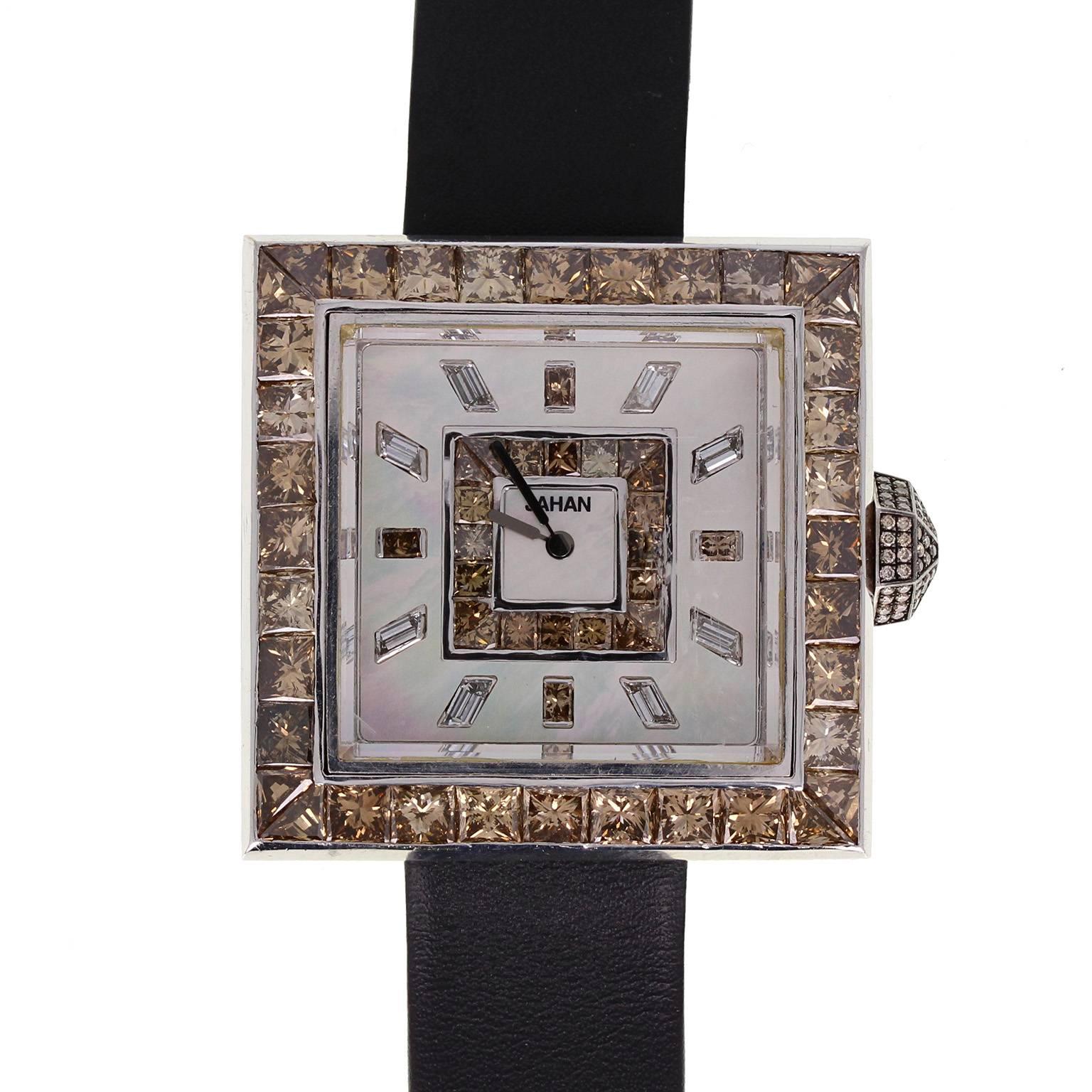 A fine and impressive diamond set watch in 18 carat white gold by Jahan. Mounted with princess-cut cognac diamonds and diamond set winder. Baguette-cut diamond index. Limited edition and numbered 001. Leather buckle strap.
 
Case
Tests as 18