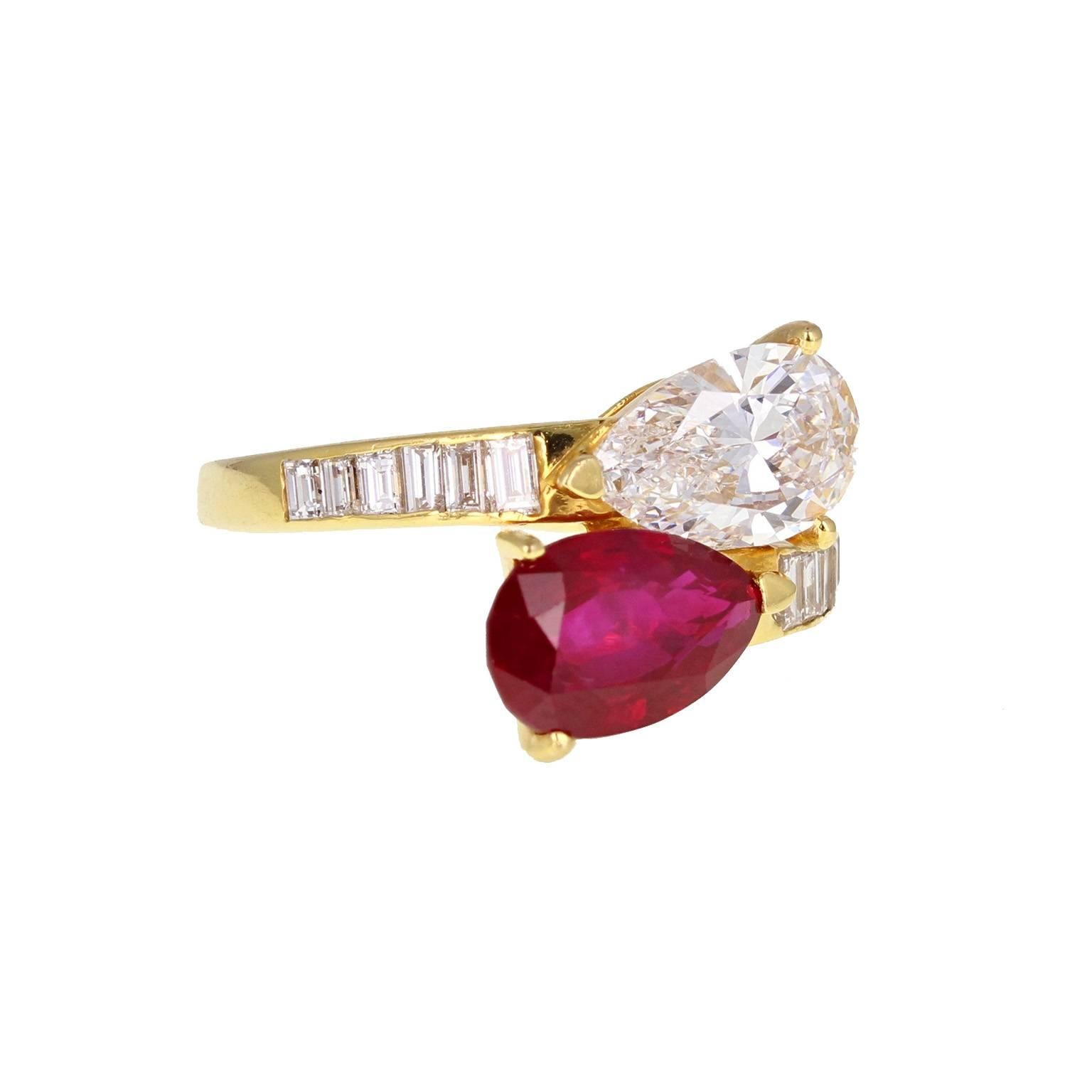 A fine and impressive 'toi et moi' ring, or 'you and me'. A perfectly matched pear-shaped ruby and pear-shaped diamond are mounted on a cross-over in 18 carat gold. Channel-set baguette-cut diamonds adorn the shoulders, leading to a tapering shank.