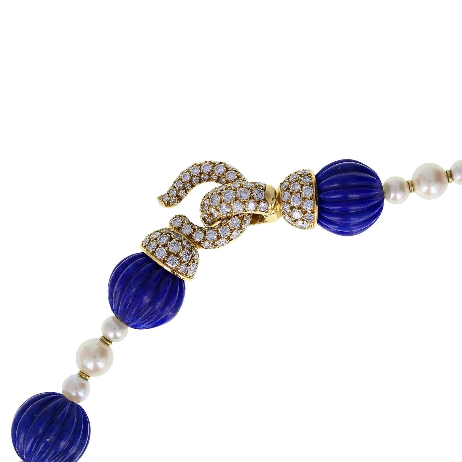 An exquisite sautoir by Cartier Paris. 26 ribbed beads of well-matched lapis lazuli are strung on silk, each interspersed with a trio of pearls, themselves separated by a pair of gold rondels. The eye-and-hook clasp is formed from 18-carat yellow