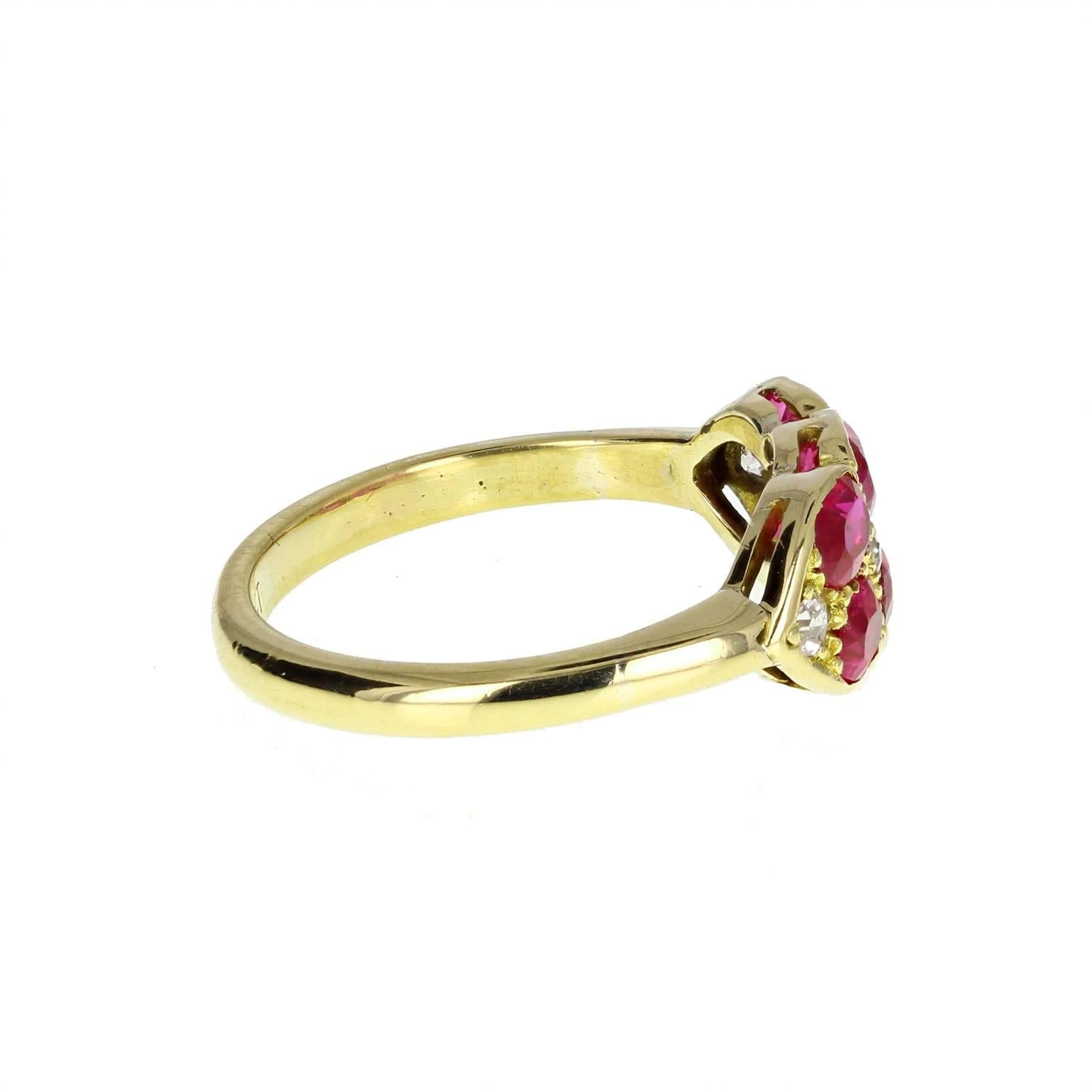 A fine quality antique victorian cluster ring. Six cushion cut rubies of well-matched colour and shape mounted in an 18 carat gold setting in two rows of three. Accented with four old-cut melee diamonds. Polished 18 carat gold shank. Stamped '18ct'