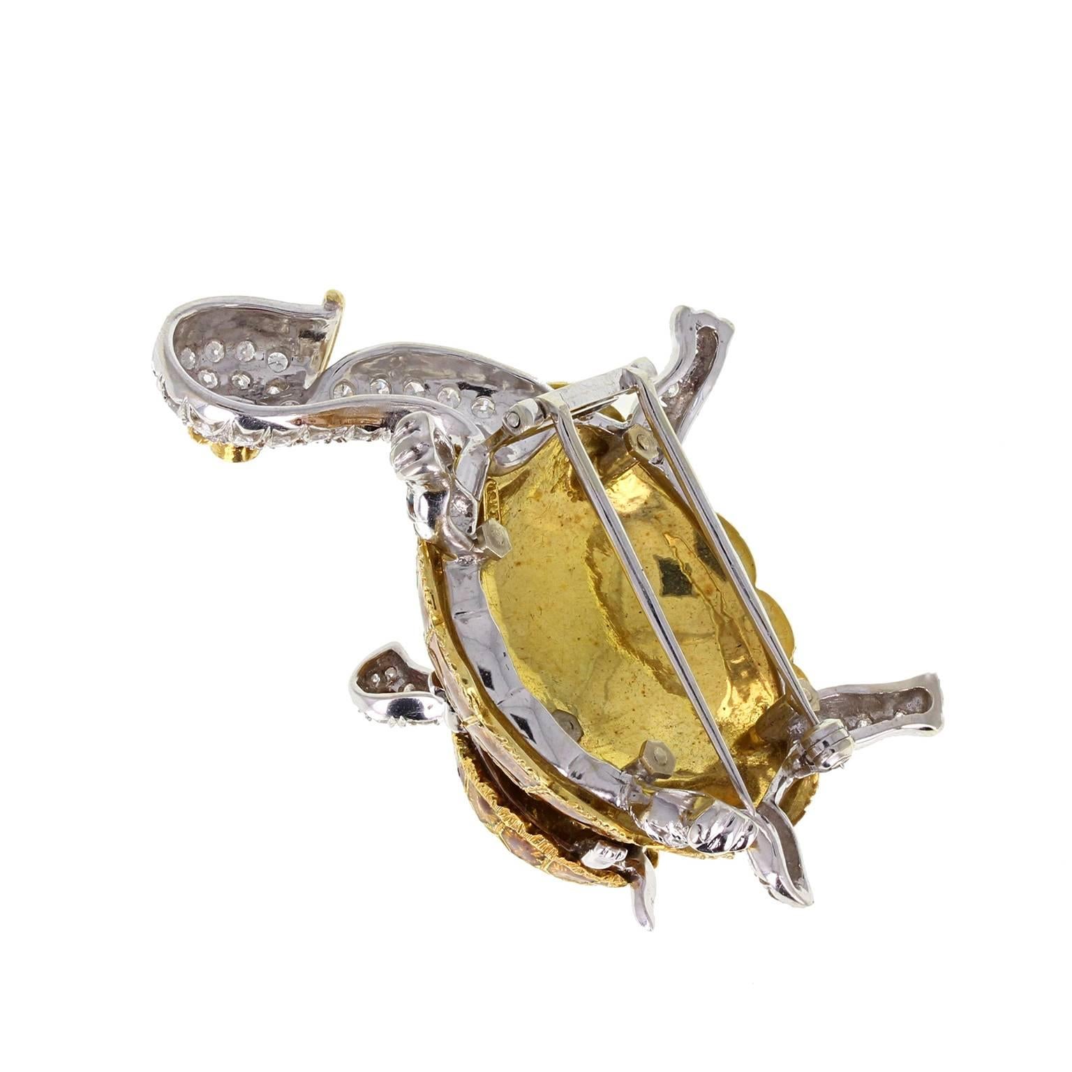 A charming vintage brooch fashioned from 18 carat gold in the form of a mother tortoise, with a baby tortoise riding on her back. Tortoise shell detail is formed from beautiful enamel, with the legs, neck and head pavé set with diamonds. Each has a