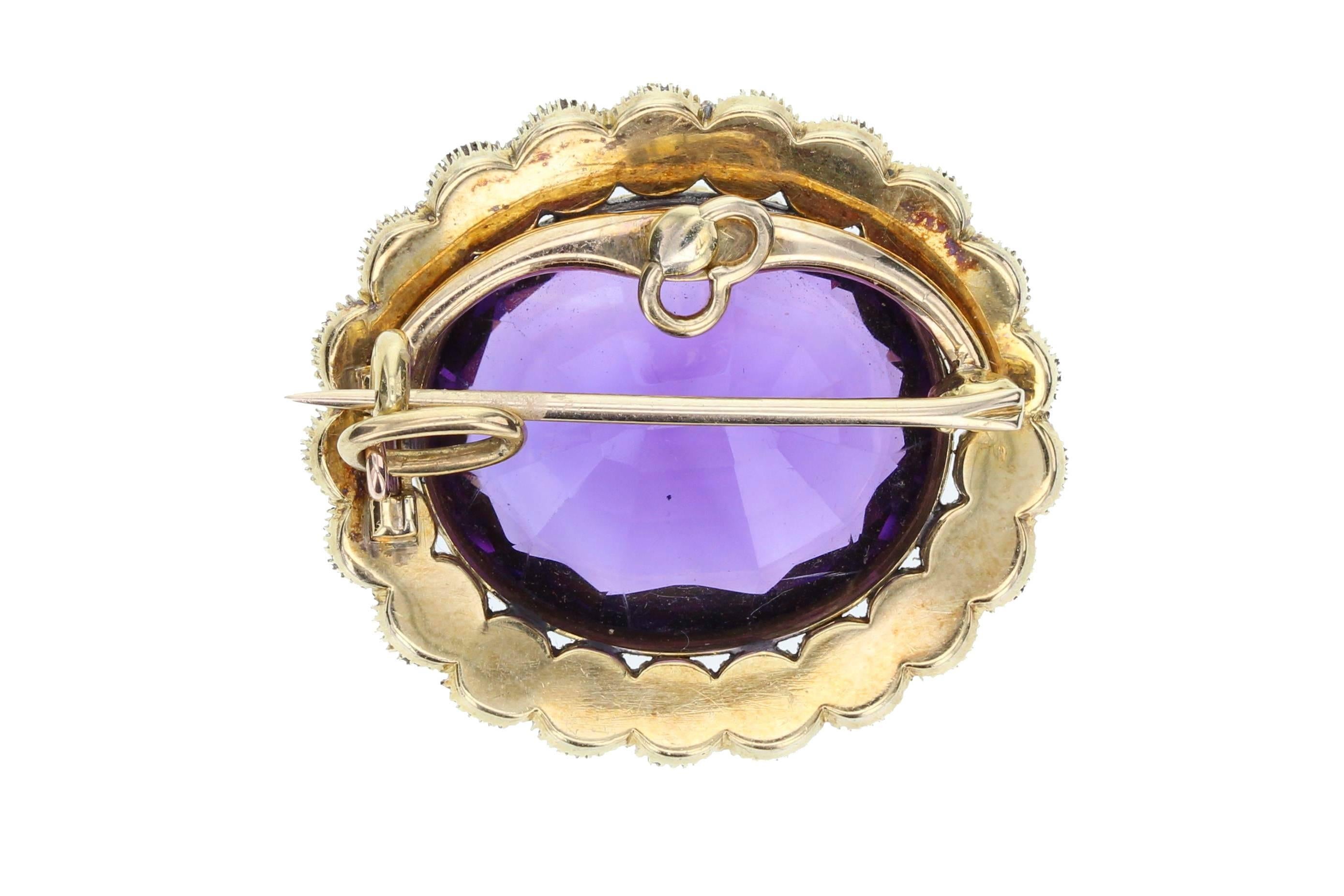 A late Victorian brooch/pendant featuring a large oval amethyst of deep, velvety purple colour, surrounded by a border of 21 seed pearls all mounted in 18 carat gold. Brooch pin fitting that can be removed and a hinged bale so it can be worn as a