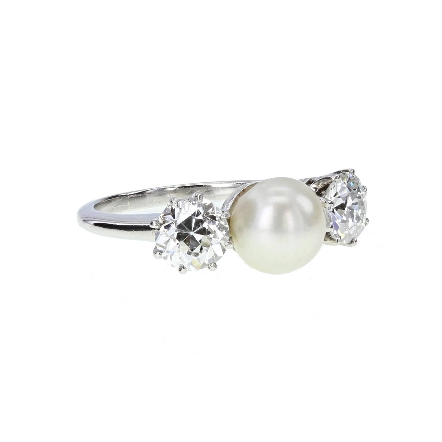 Of exceptional quality and in excellent condition this antique platinum ring comprises a central 6.5mm pearl flanked on each side by a claw-set old-cut diamond of impressive brilliance and show.
 
Shank and Setting
Tests as platinum
