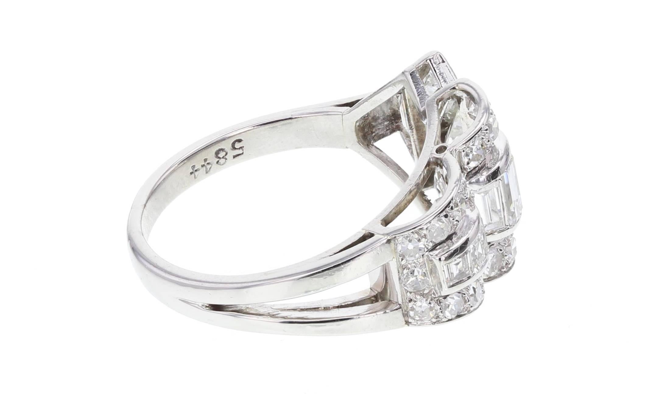An exceptional example of Art Deco style. This geometric diamond cluster ring is crafted in platinum and contains a mixture of cuts giving it a compelling and unmistakable look. A great, stylish period piece sure to impress.
 
Shank and