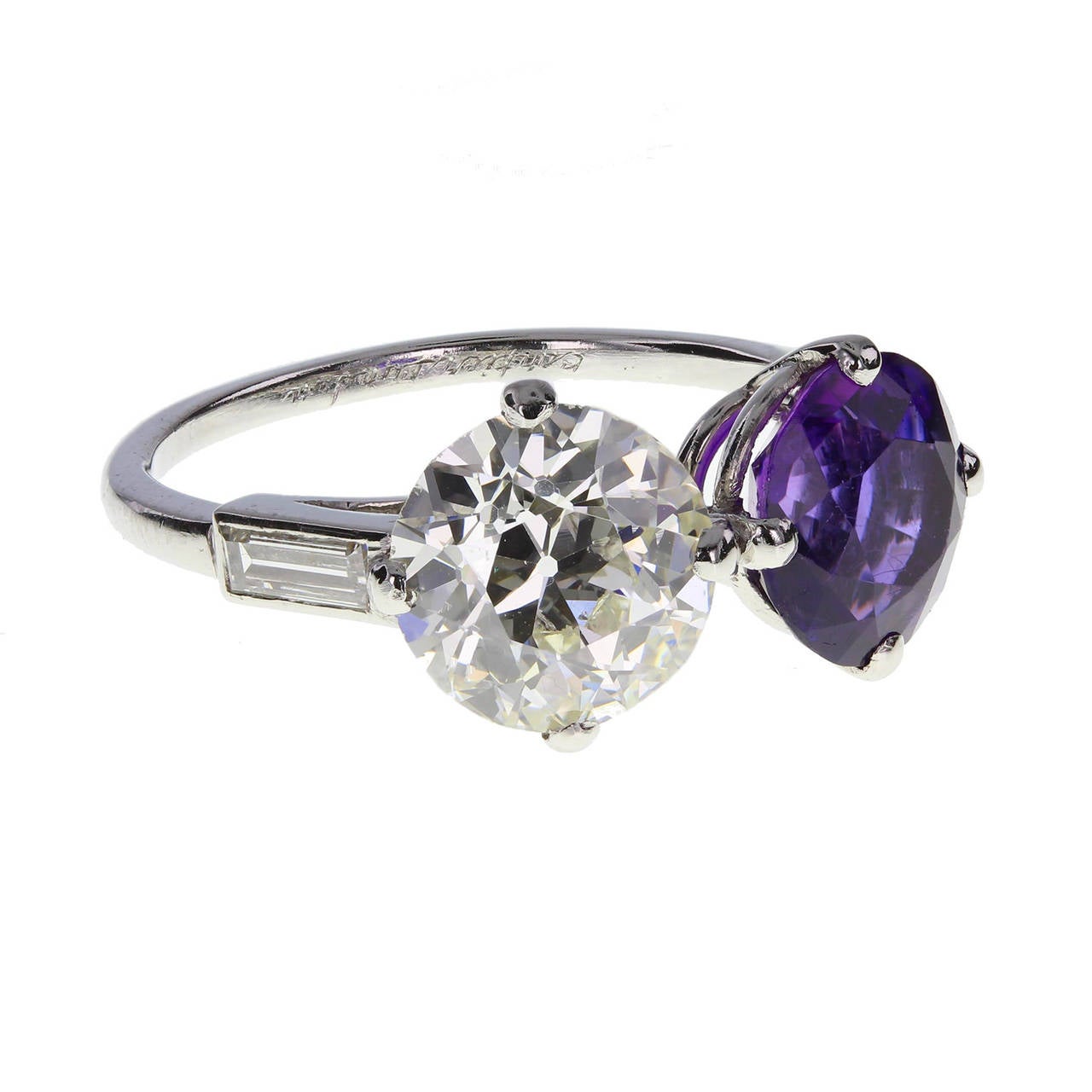 In excellent condition, this two-stone ring in platinum by Cartier features a 1.75 carat, old-cut diamond and a 1.40 carat round-cut amethyst of deep purple, mounted side-by-side each in four claws. Exceptional sparkle and scintillation. Signed