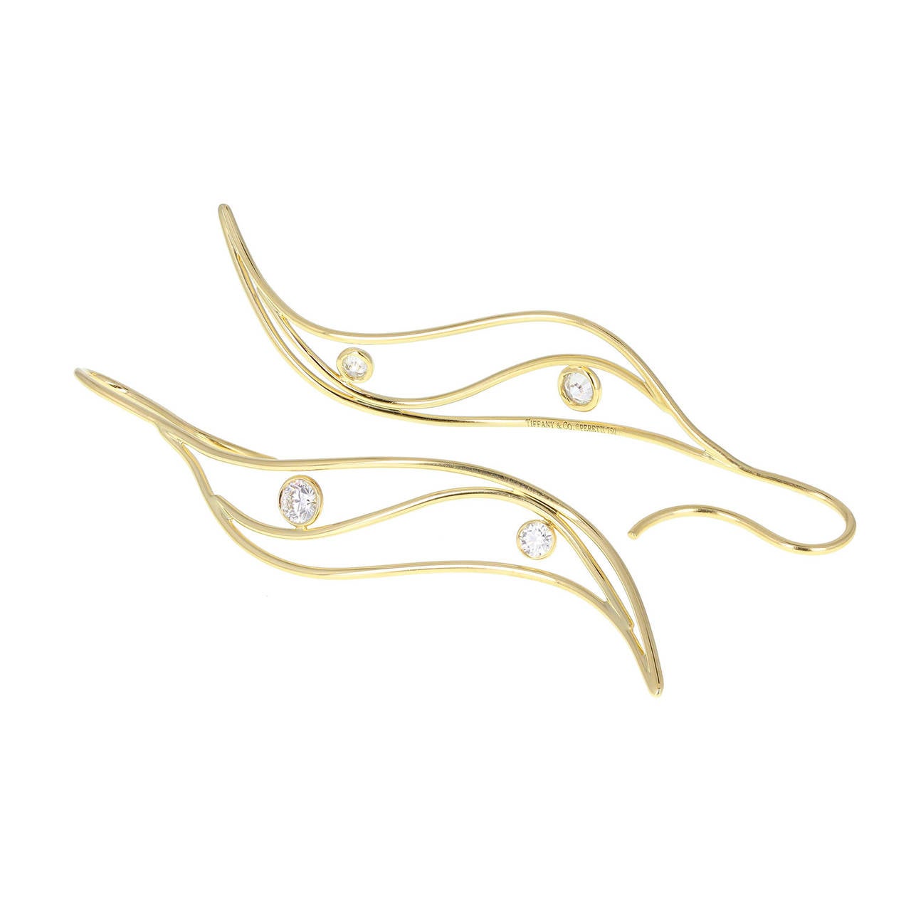 Designed by Elsa Peretti for Tiffany & Co. in the form of two organic curved leaf drops. Fashioned from 18 carat gold wire and each set with two round brilliant-cut diamonds totaling 0.60 of a carat with G colour and VVS clarity. Signed Tiffany &