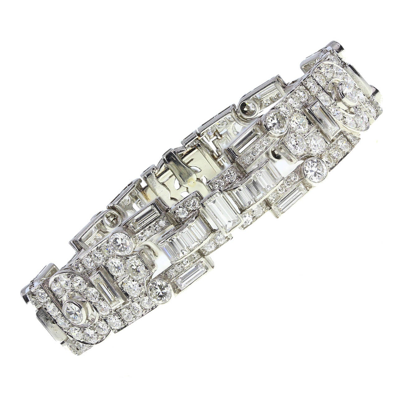 Rampant Art Deco bracelet featuring the typical geometric patterned panels of the era. Set with brilliant-cut and baguette-cut diamonds. Tongue fastening with safety clasp. Approximately 20.00 carats of diamond in total, G-H colour, VS clarity. In