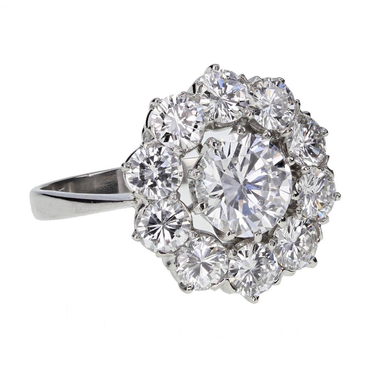 This top quality diamond daisy cluster ring is mounted in platinum. The central brilliant-cut diamond is accompanied by an HRD certificate stating that it is 1.38 carats, D colour and internally flawless clarity. Surrounded by ten further